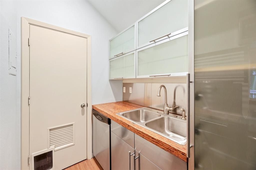 A kitchen with stainless steel cabinets and a sink