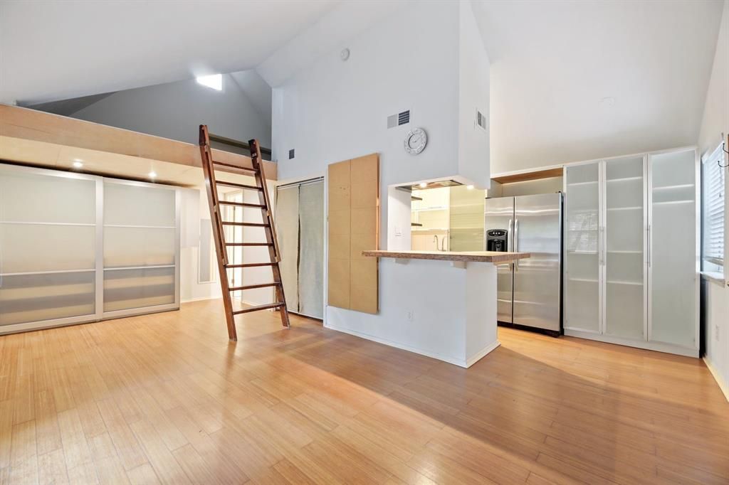 An empty room with a staircase leading up to the second floor
