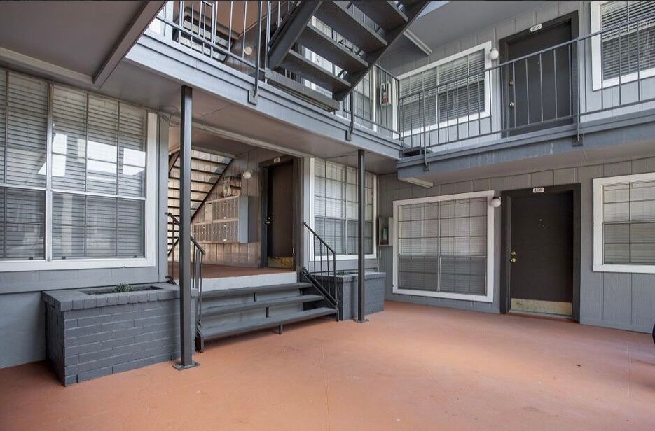 A building with stairs leading up to the second floor