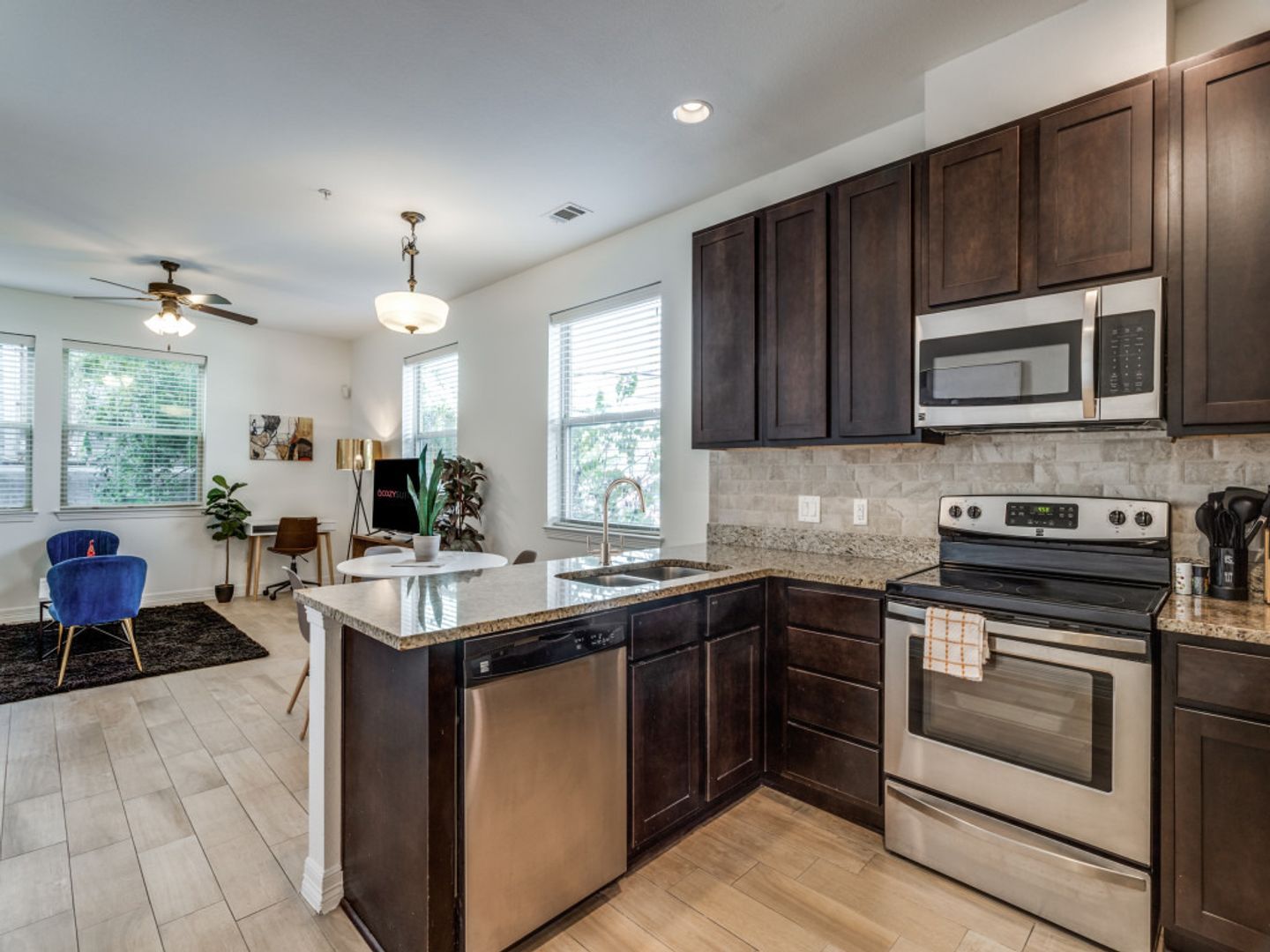 A kitchen with stainless steel appliances and wooden cabinets.