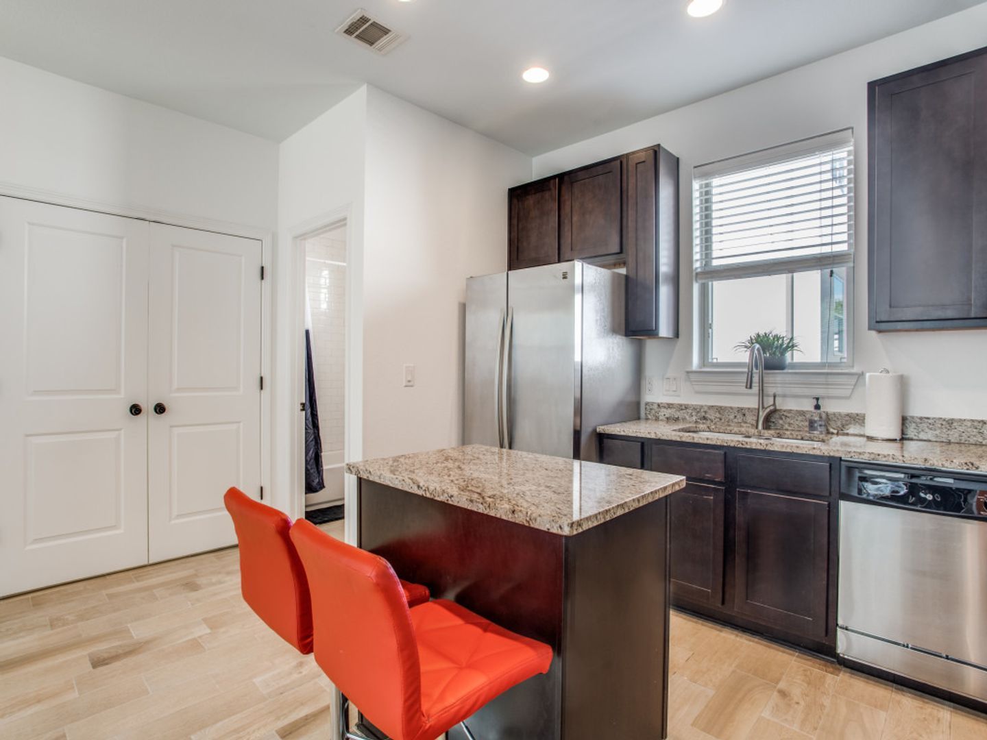 A kitchen with stainless steel appliances and granite counter tops.