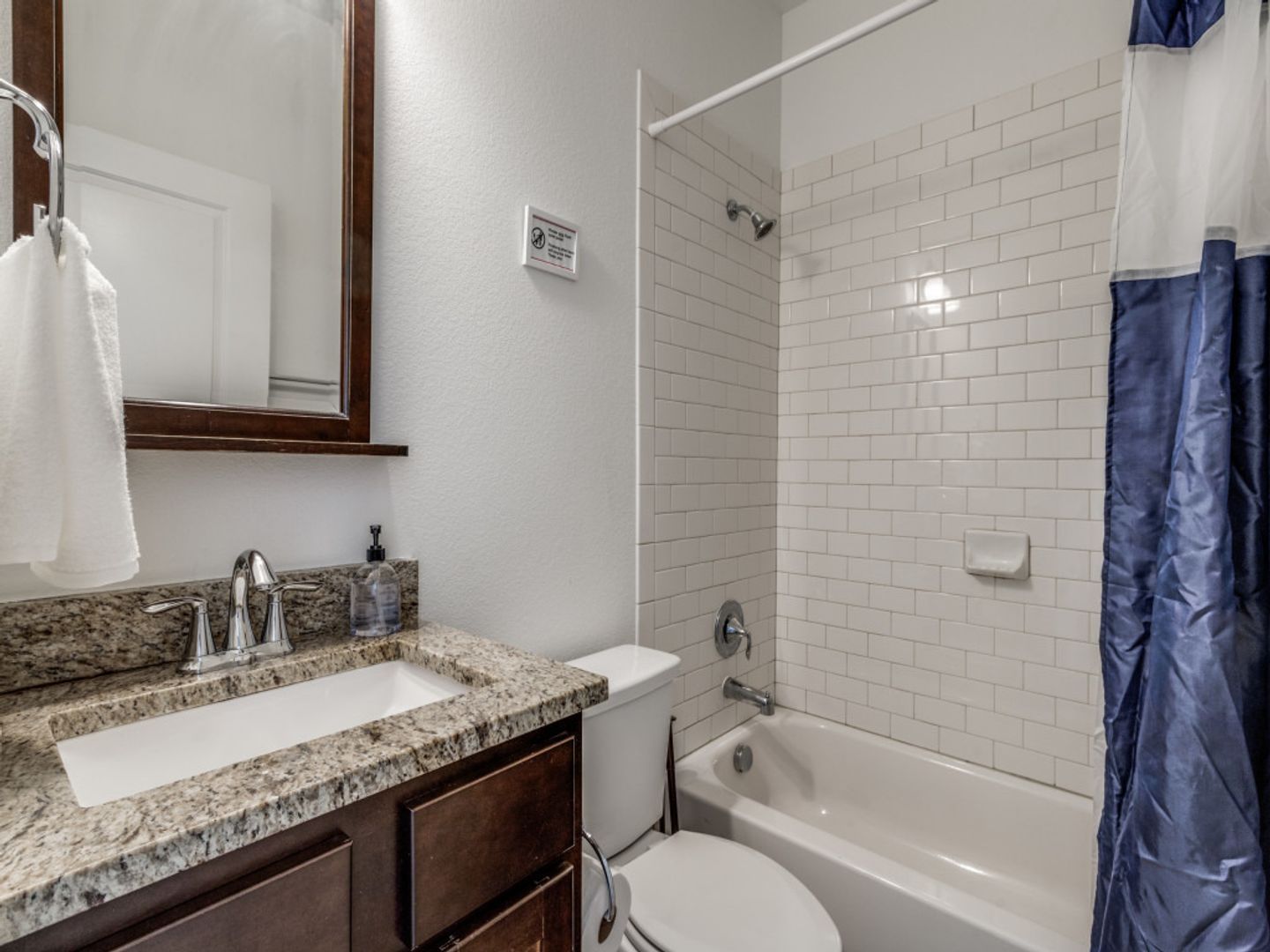 A bathroom with a toilet , sink , and bathtub.