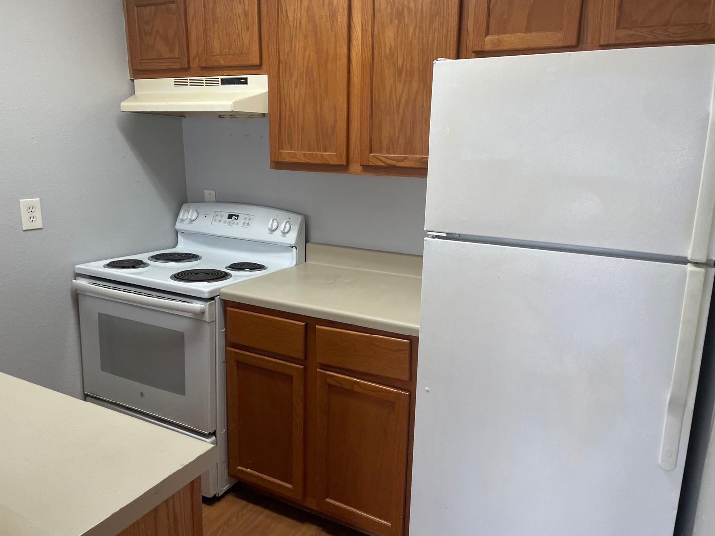 A kitchen with a stove , refrigerator and cabinets