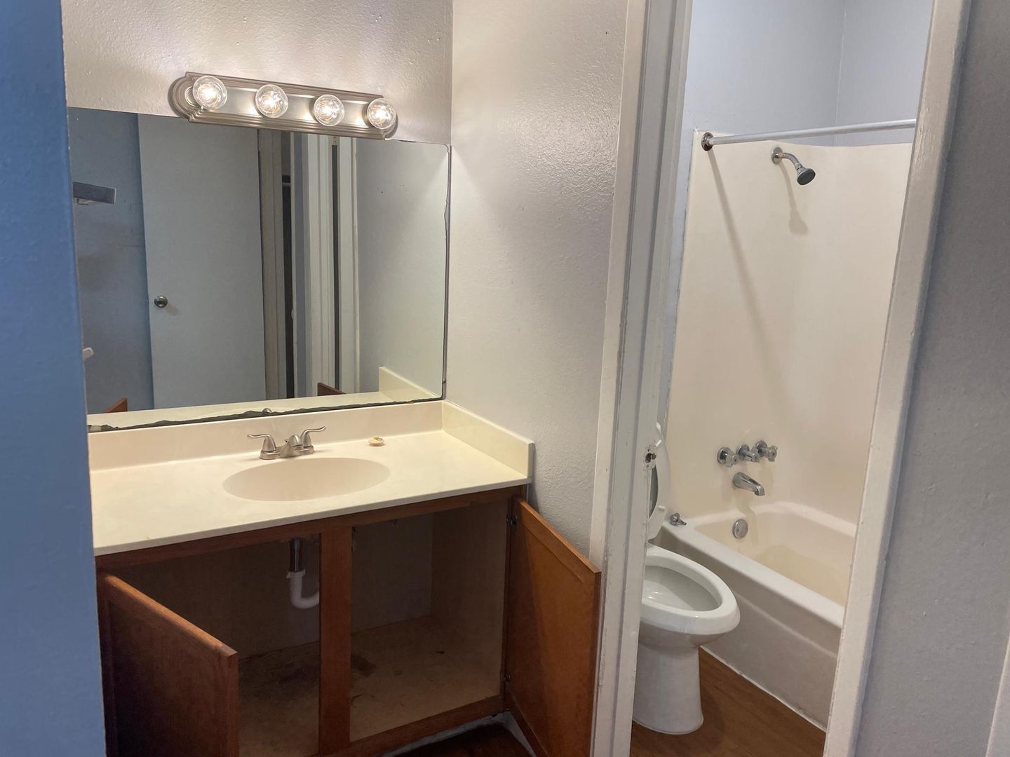 A bathroom with a sink , toilet and bathtub.