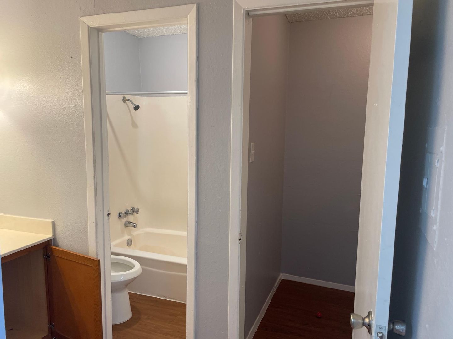 A bathroom with a toilet , bathtub and shower.