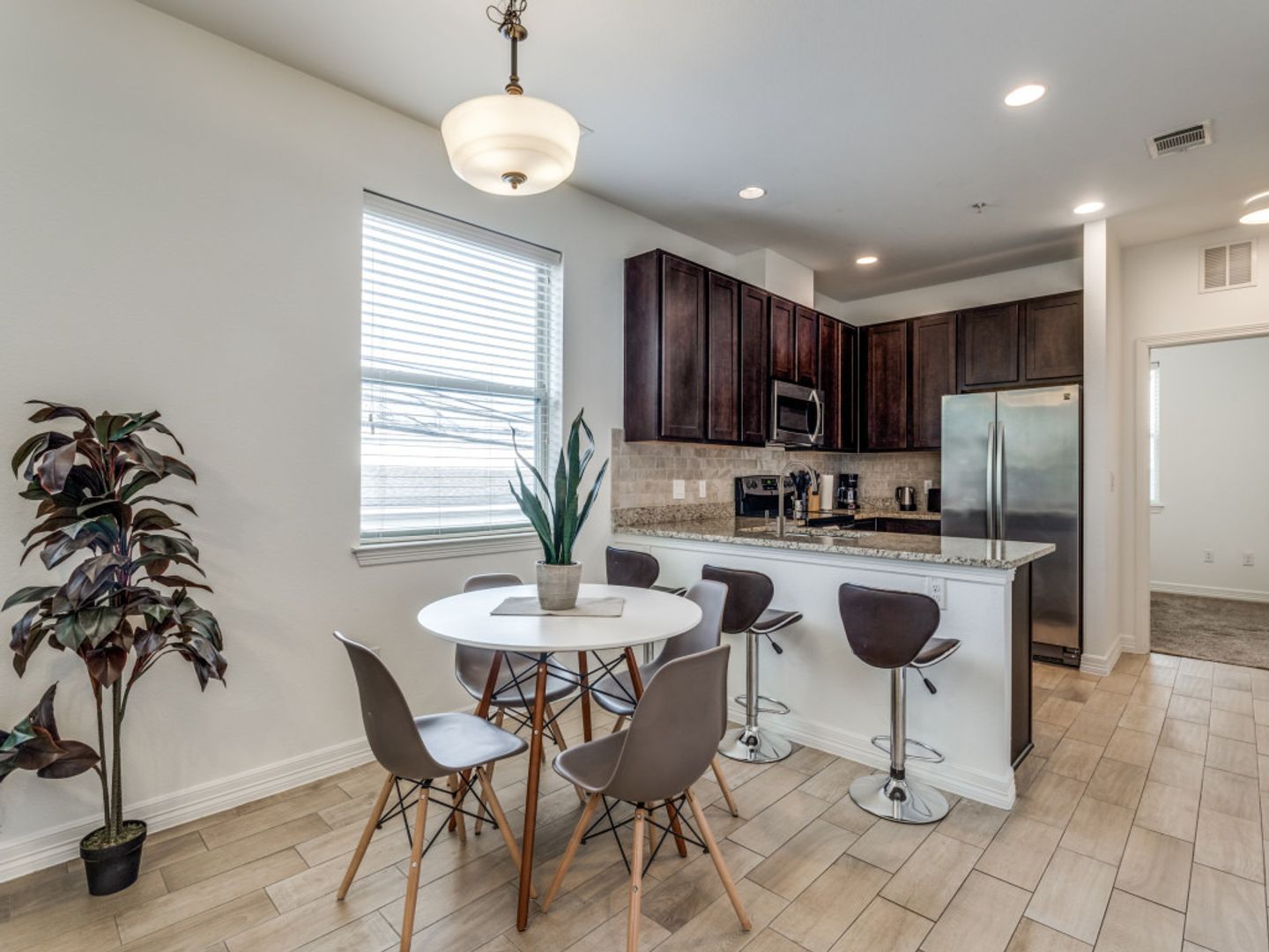 A kitchen with a table and chairs in it