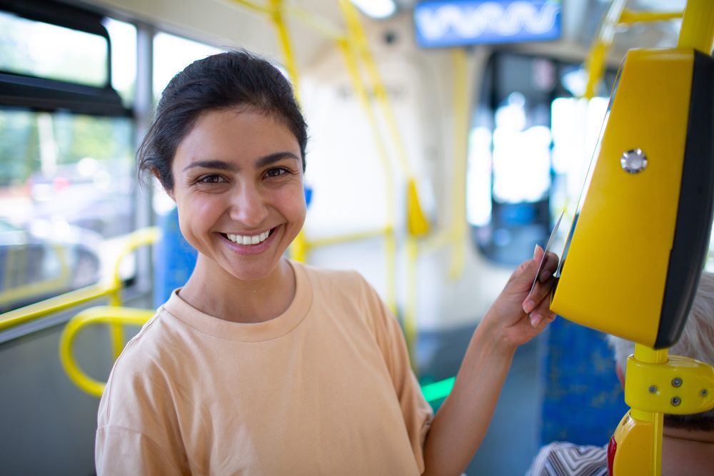 Woman Paying with Card for Public Transport — Local Newsagent in Moss Vale, NSW