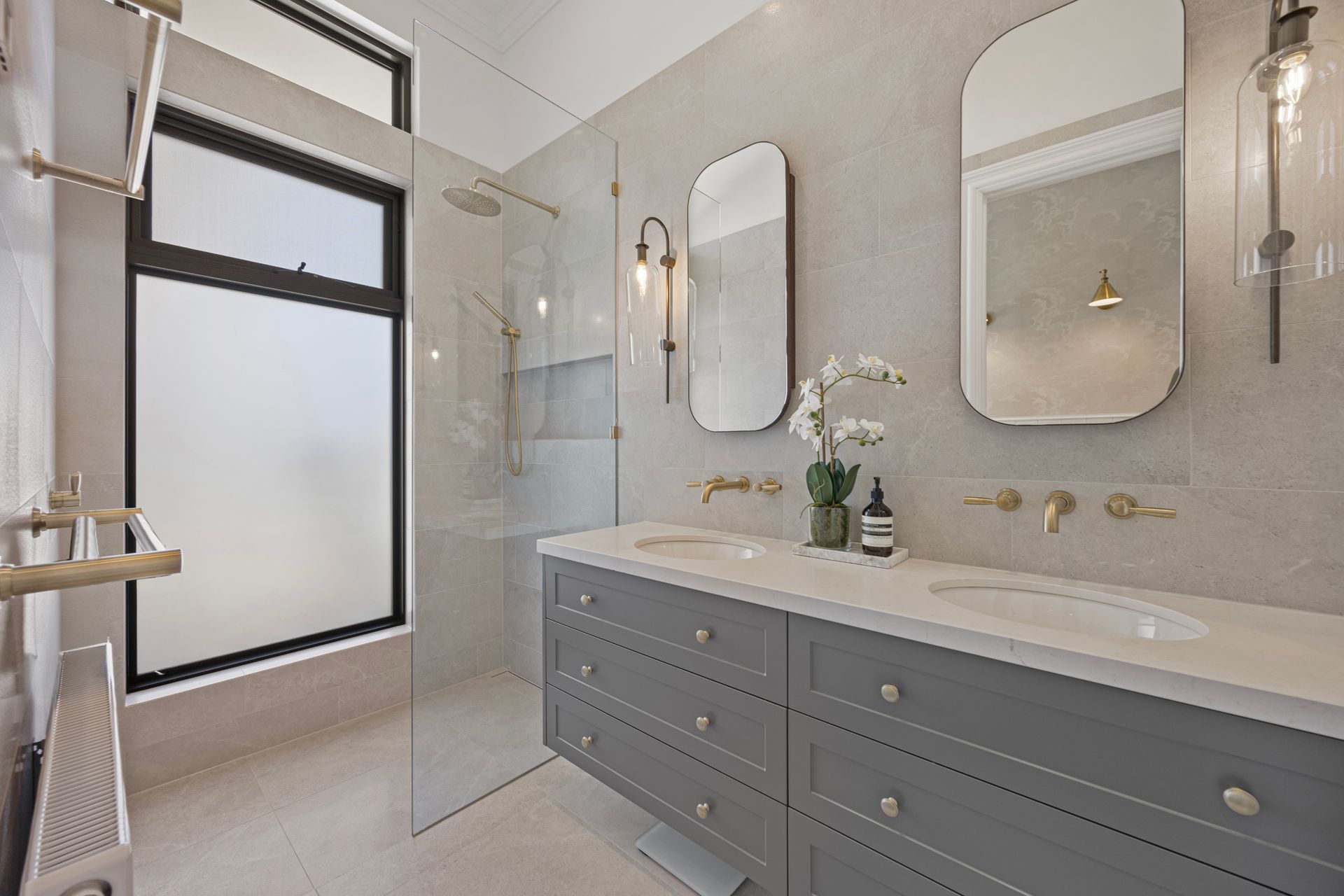 Main bathroom with twin vanity and soft feature lighting