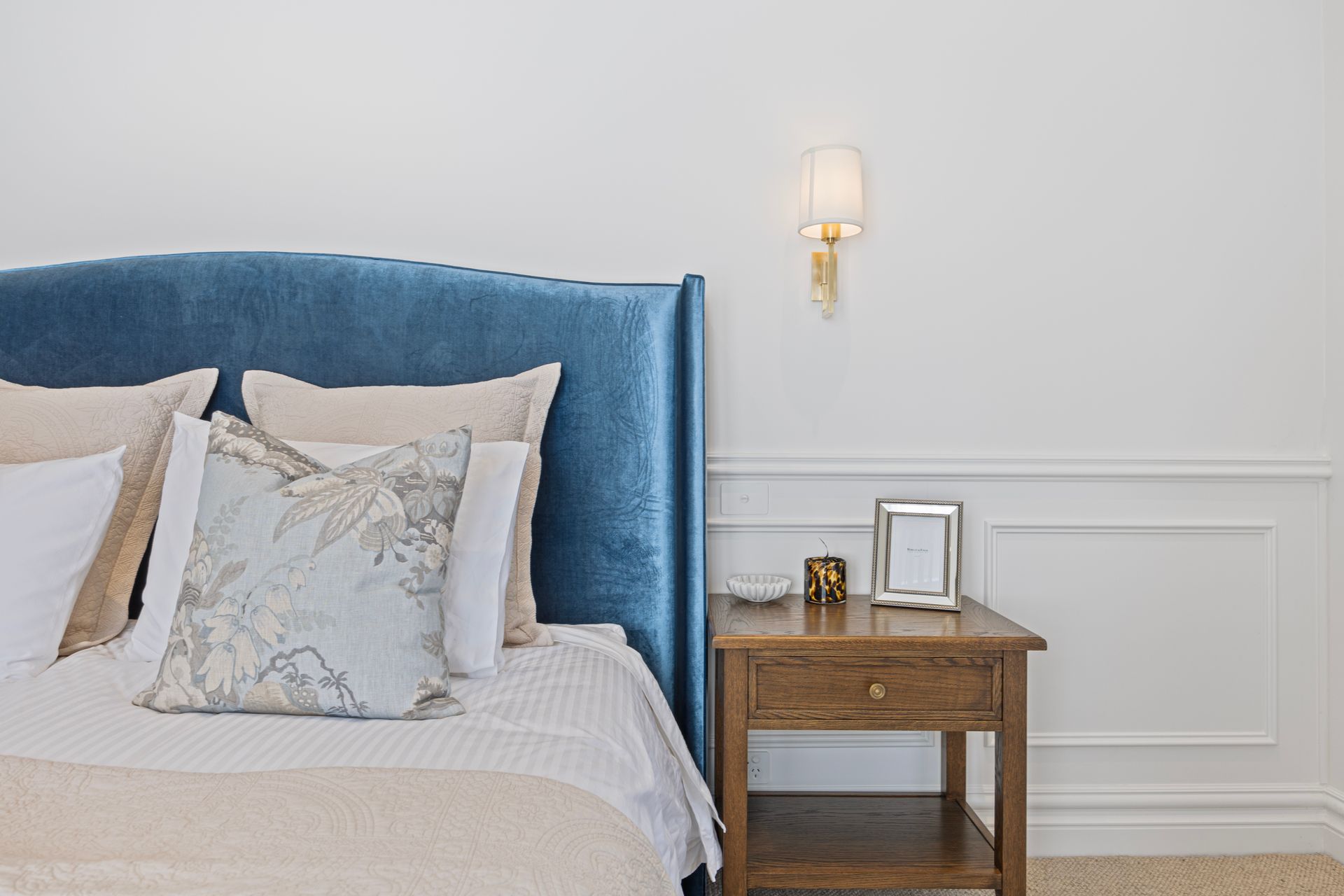 Bedroom with upholstered bedhead and layered textures
