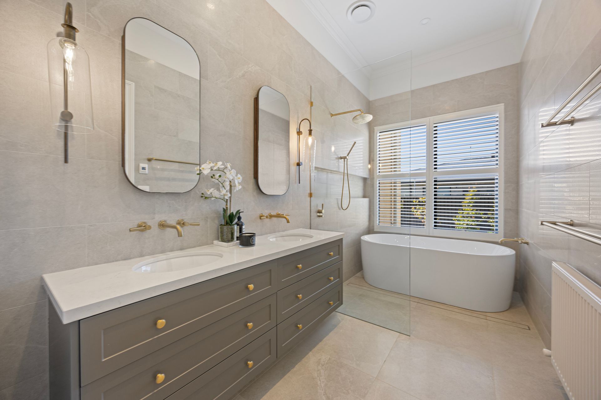 Main bathroom with twin vanity and soft feature lighting