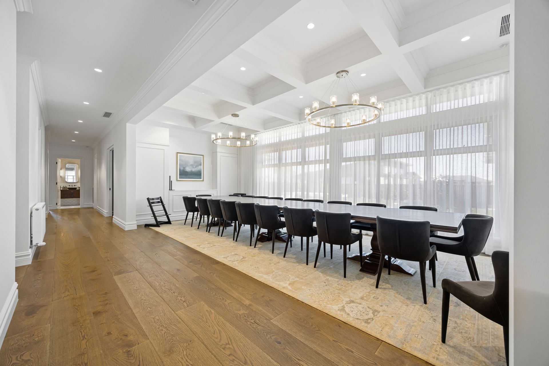 Formal dining space with pendant lights and natural timber table