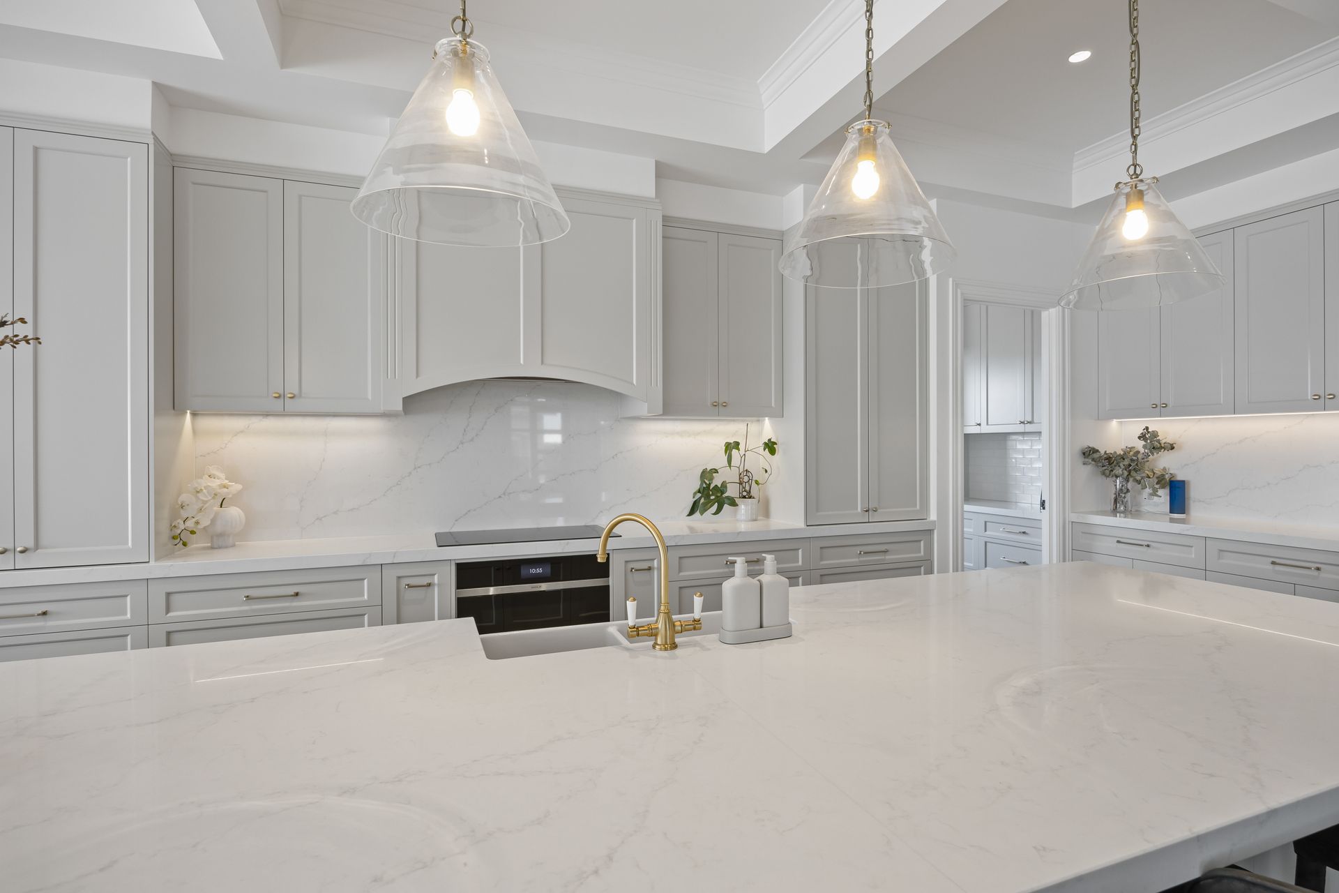 Shaker-style cabinetry with brushed hardware and stone tops