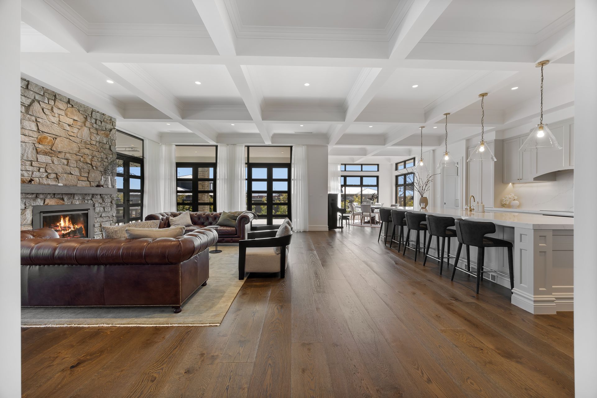 Open-plan living area with coffered ceilings and hardwood floors