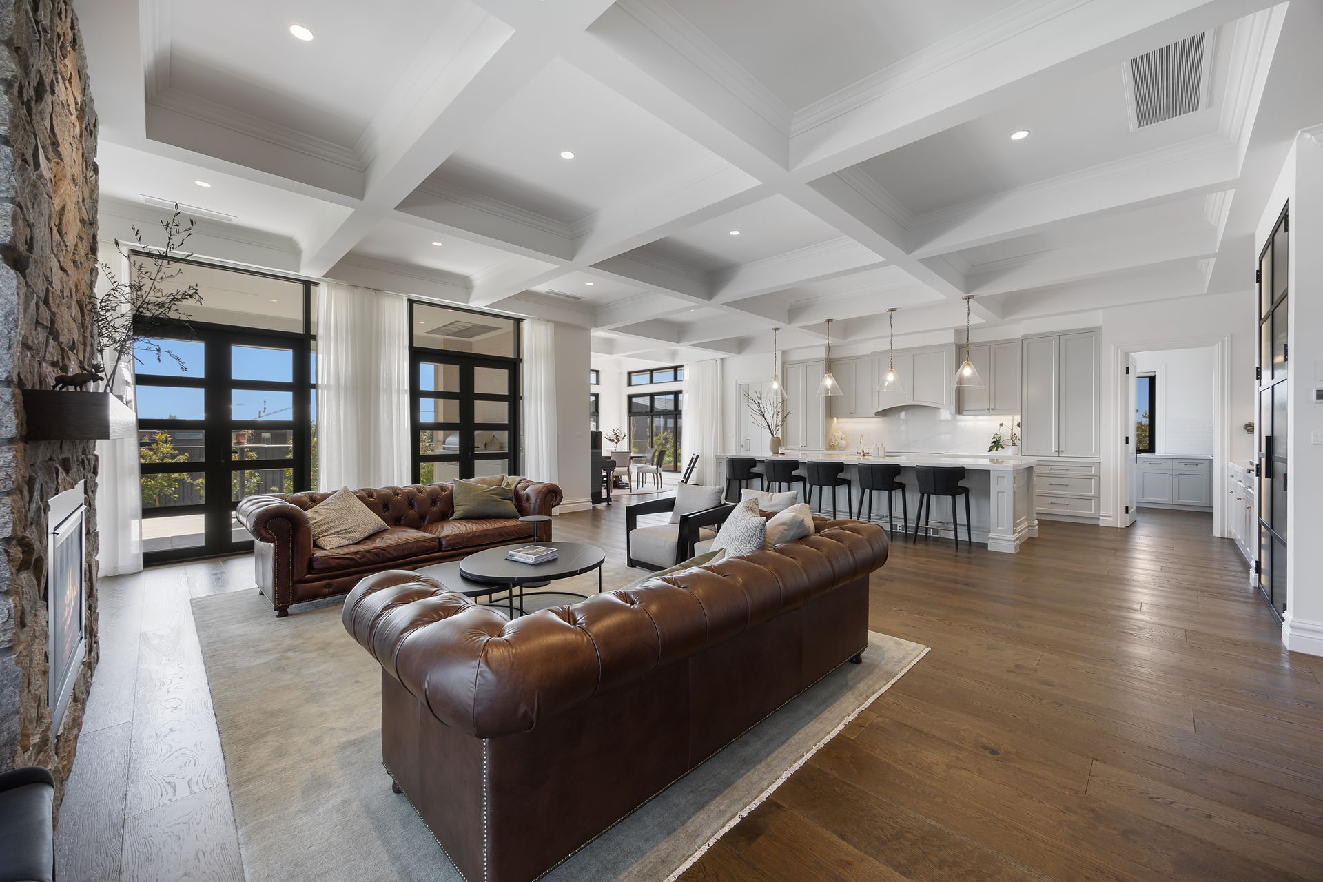 Open-plan living area with coffered ceilings and hardwood floors