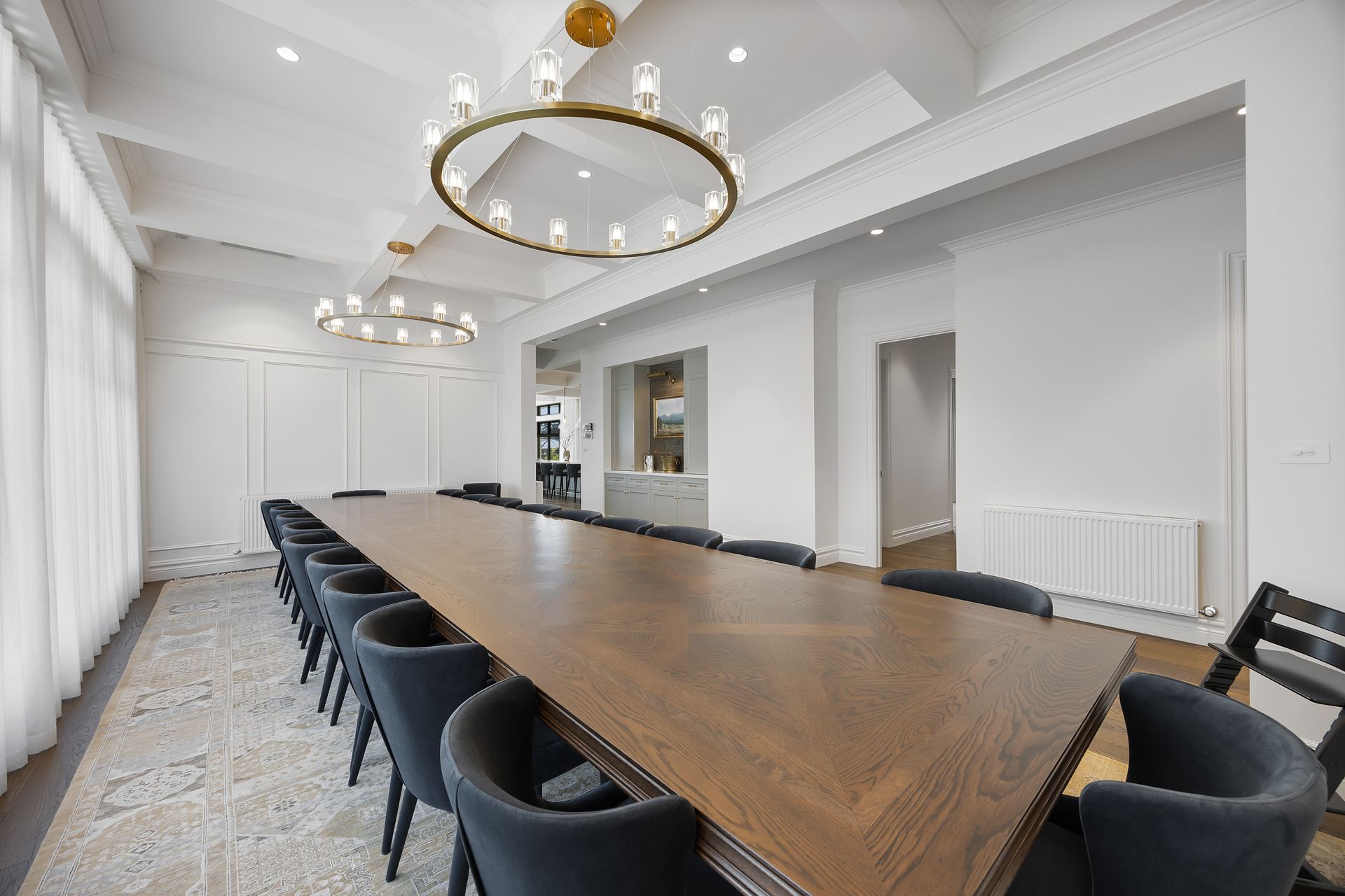 Formal dining space with pendant lights and natural timber table