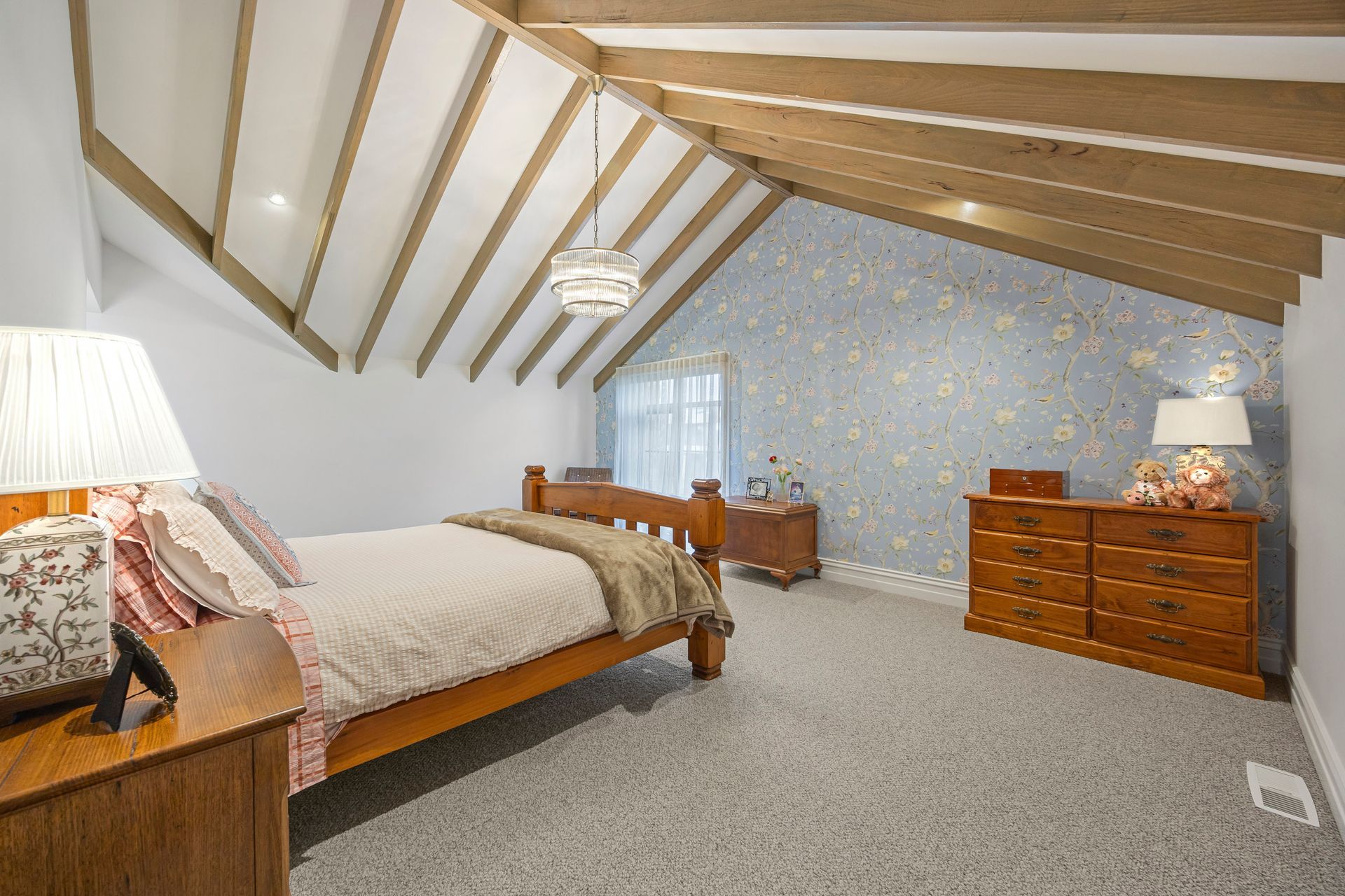 Bedroom with wallpaper feature and vaulted ceiling