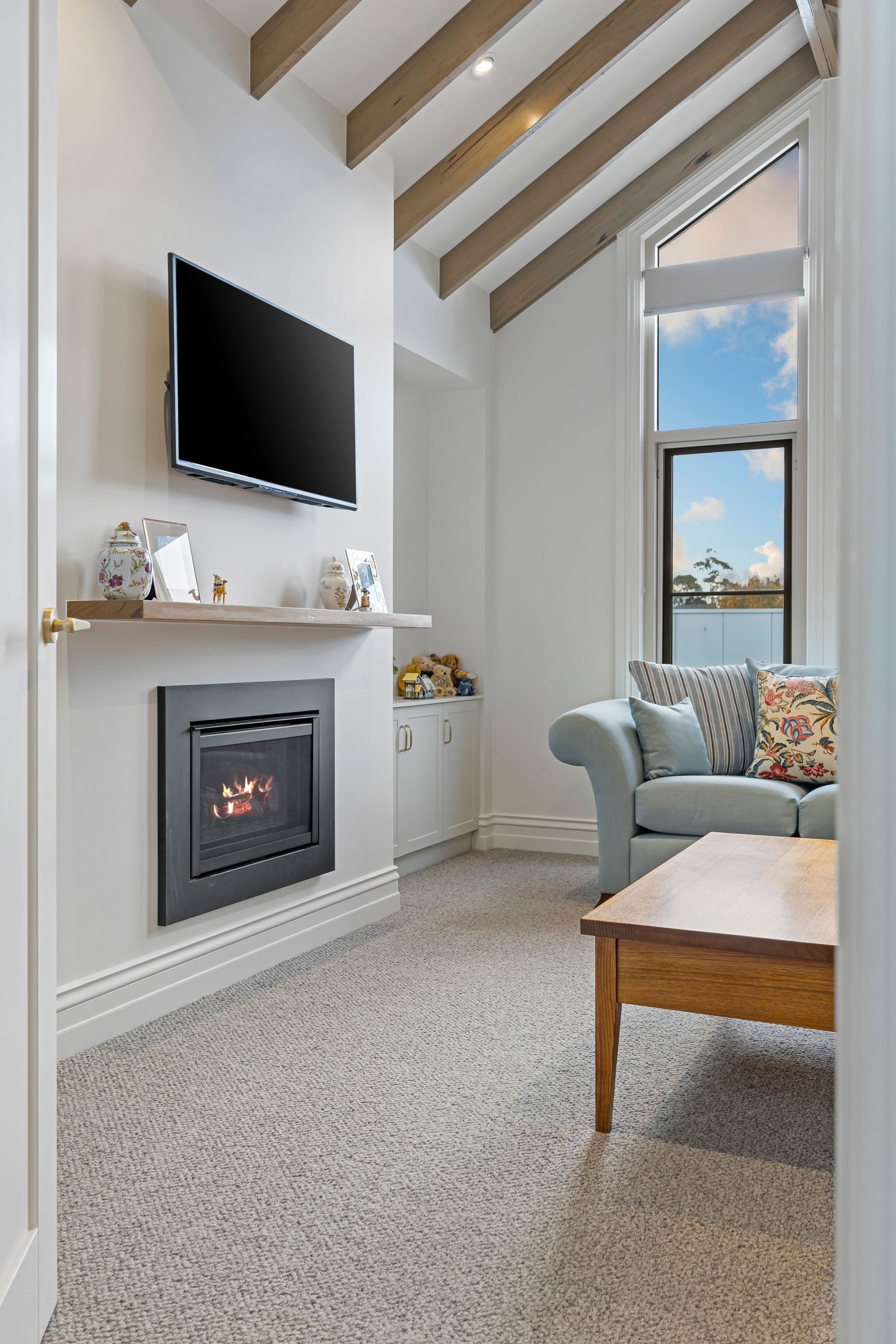 Formal lounge featuring plush armchairs and statement fireplace