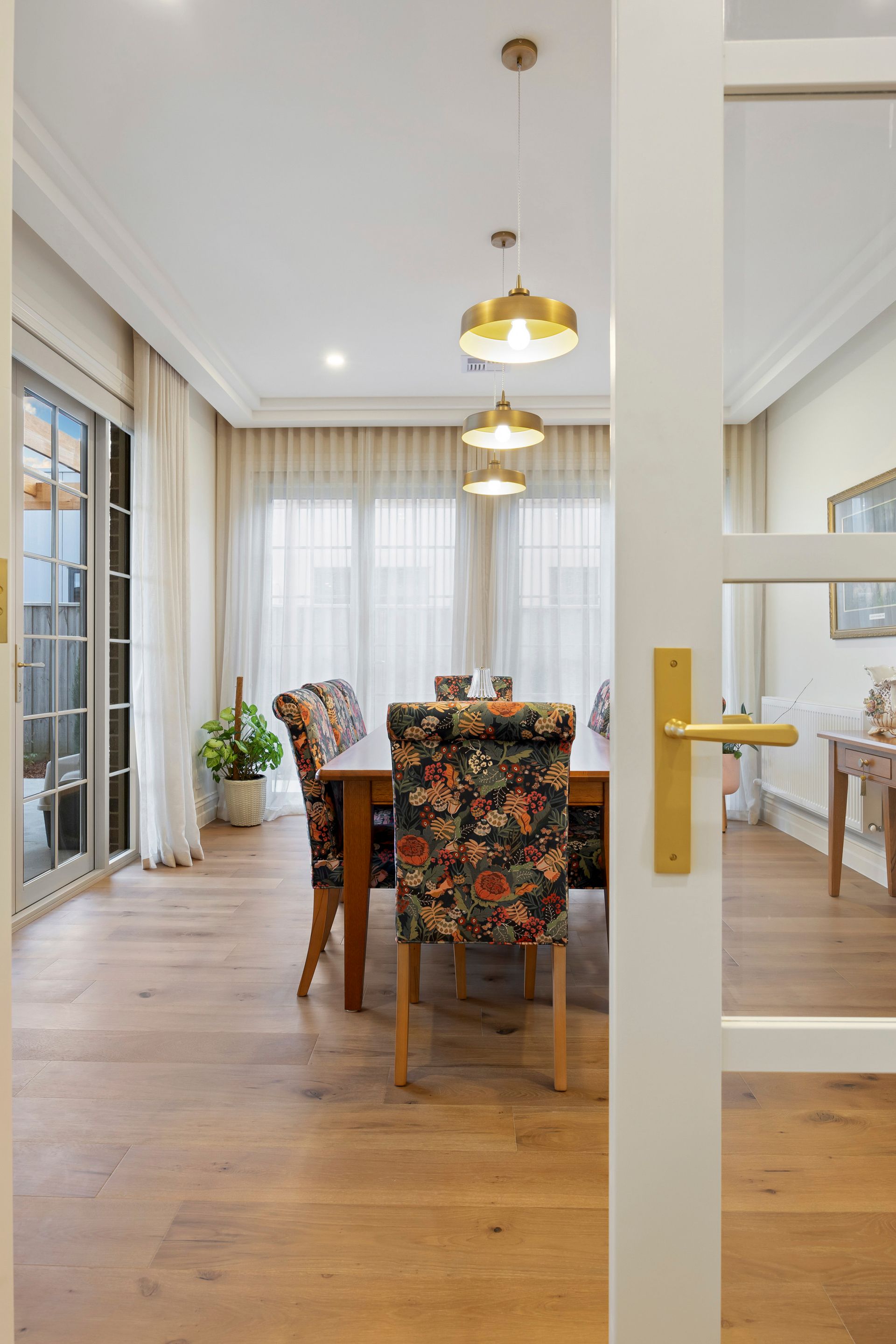 Classic dining setting with natural light and gold accents