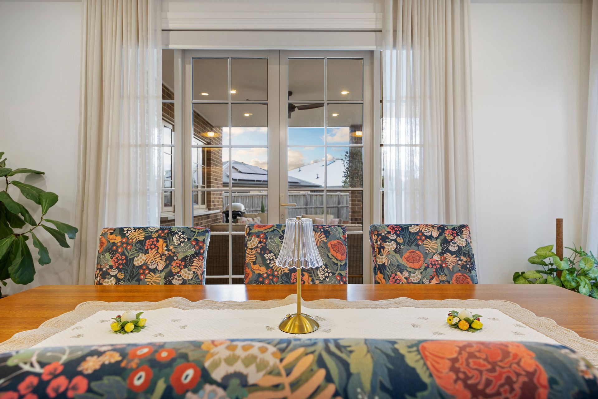 Dining area with floral upholstery and sliding glass doors