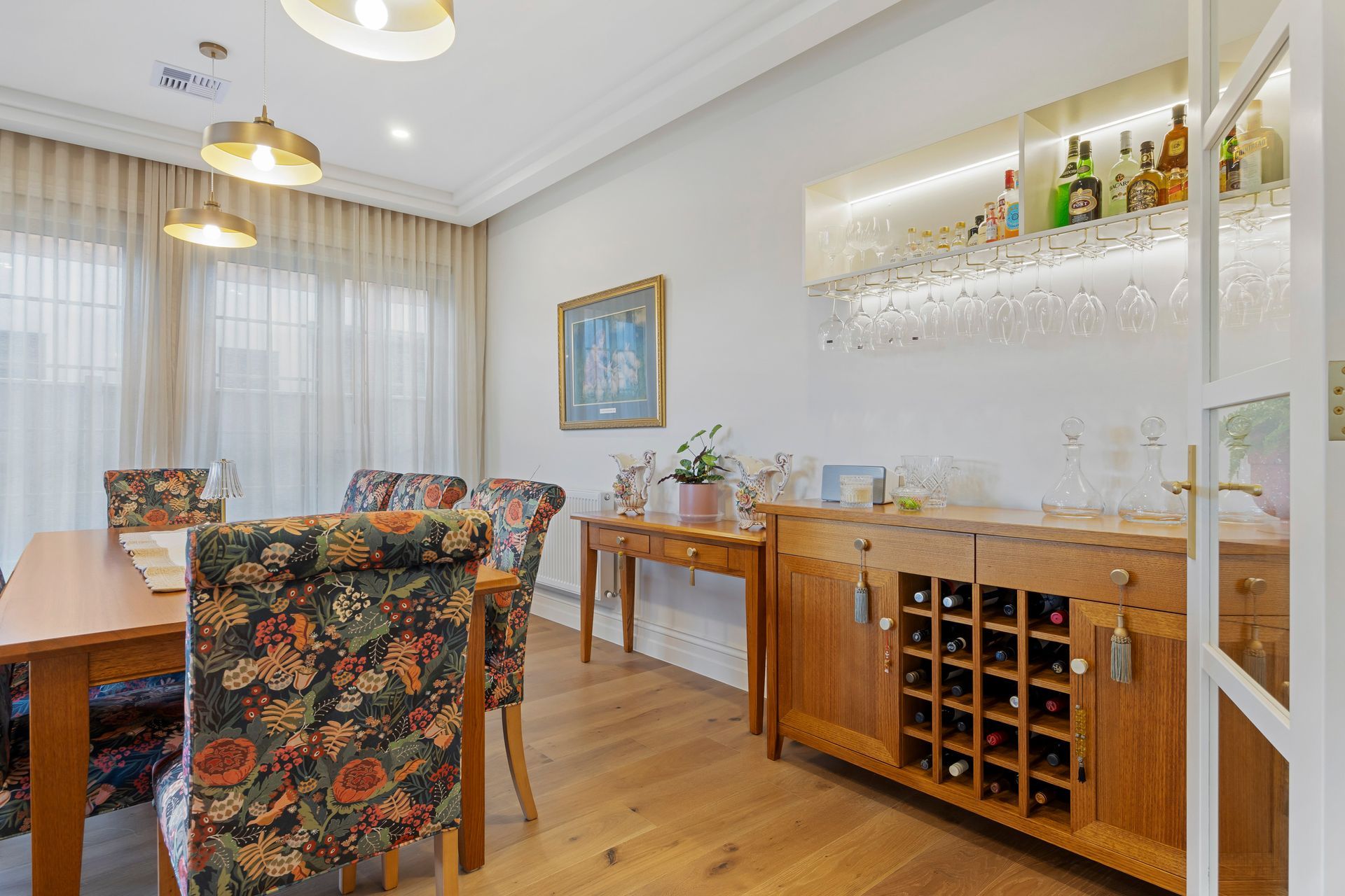 Entertainer’s dining room with timber floors and wine cabinet