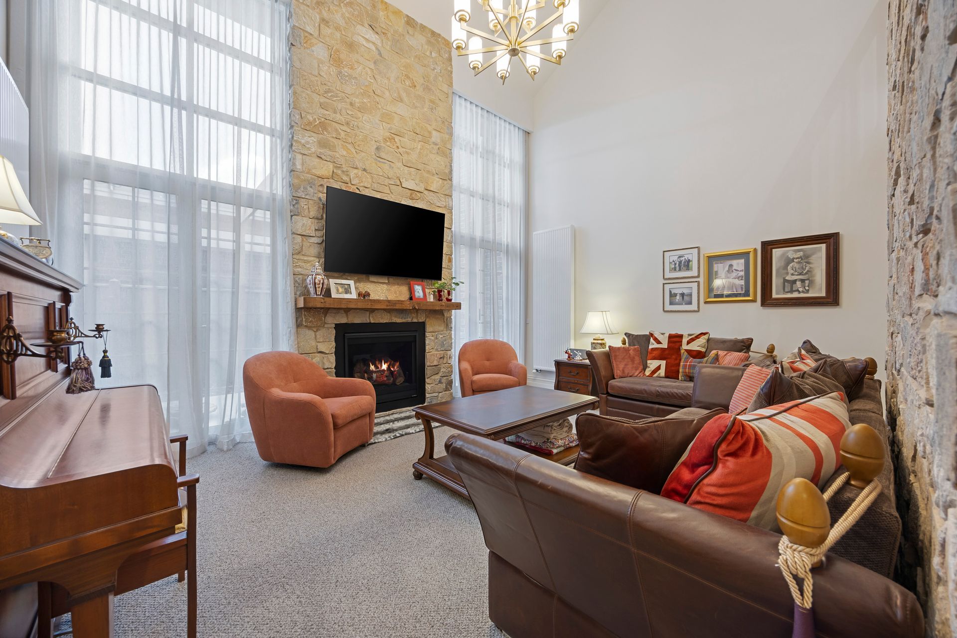 Family room with layered seating, vintage décor and high windows