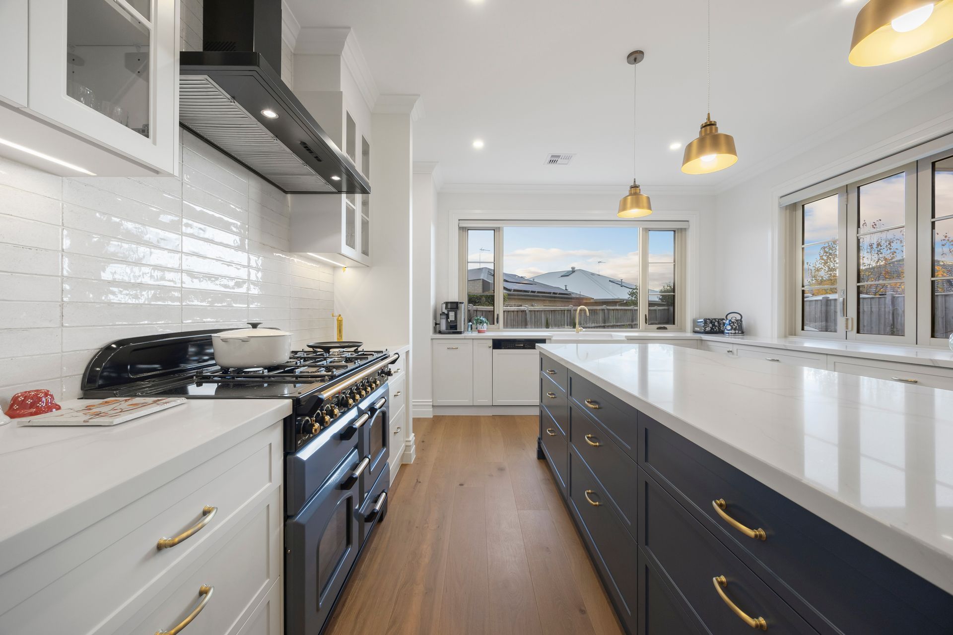 Open kitchen space with wide layout and timber floors