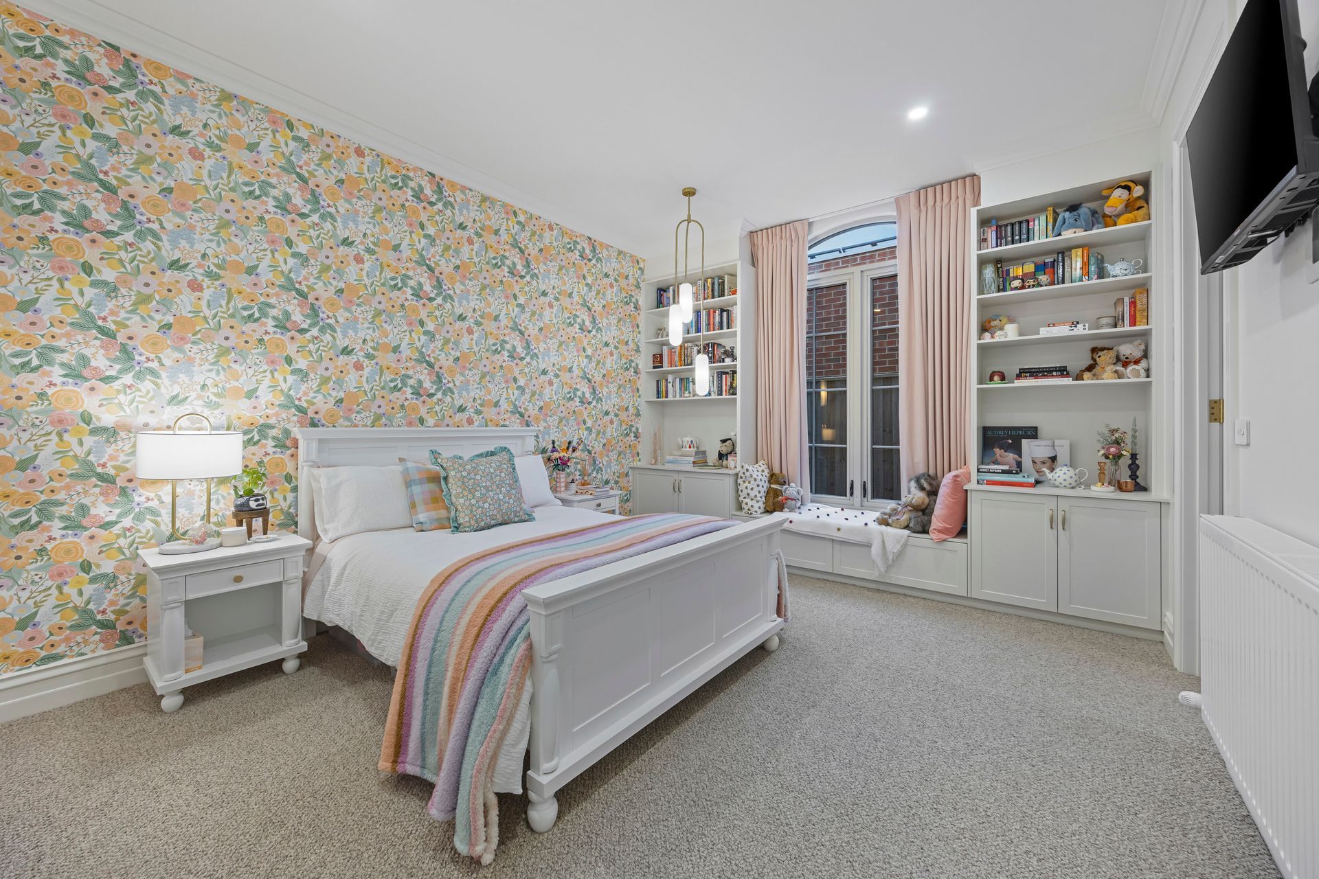 Bedroom with pastel wallpaper, open shelving and soft palette