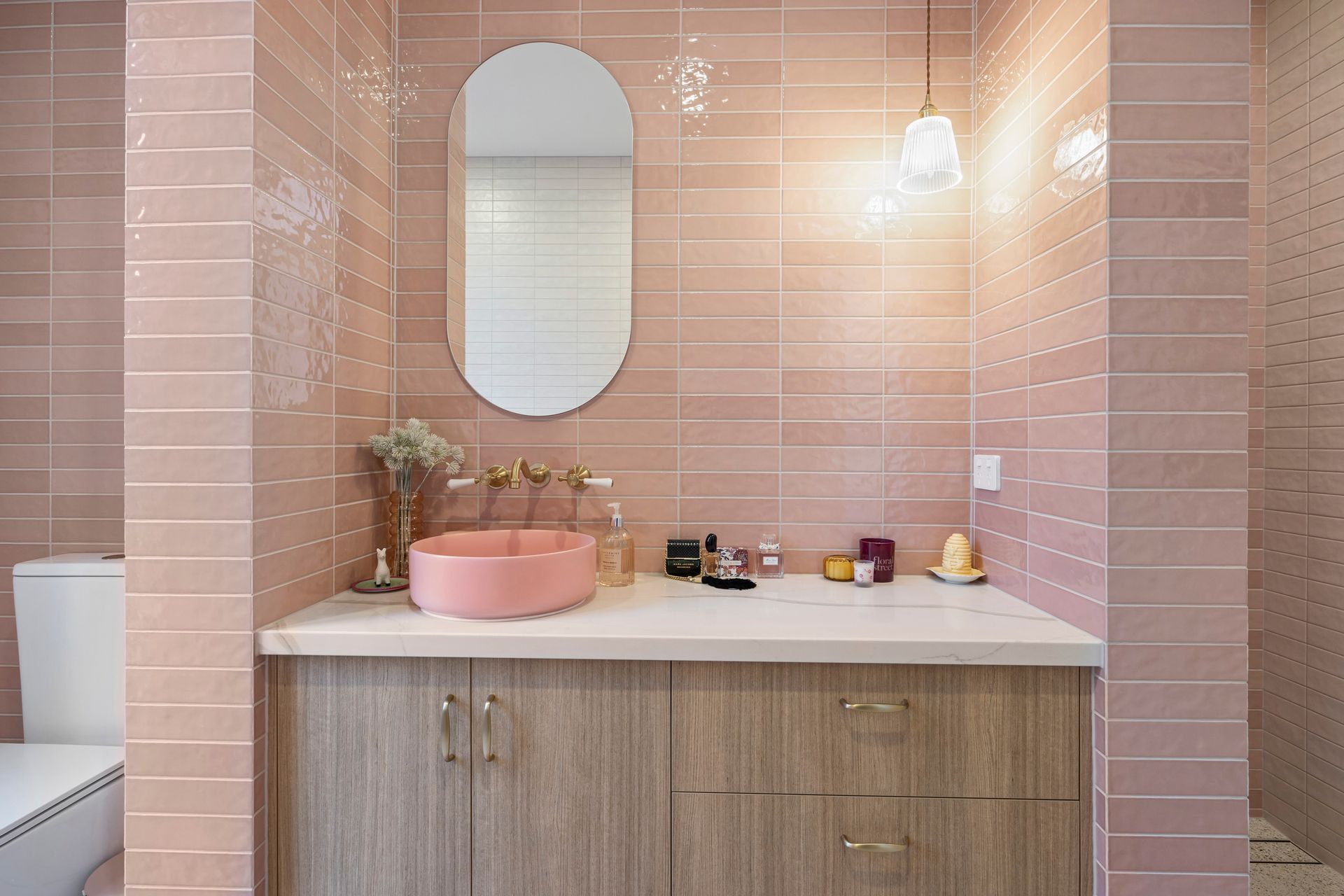 Feature wall bathroom with curved mirror and matte tile detail