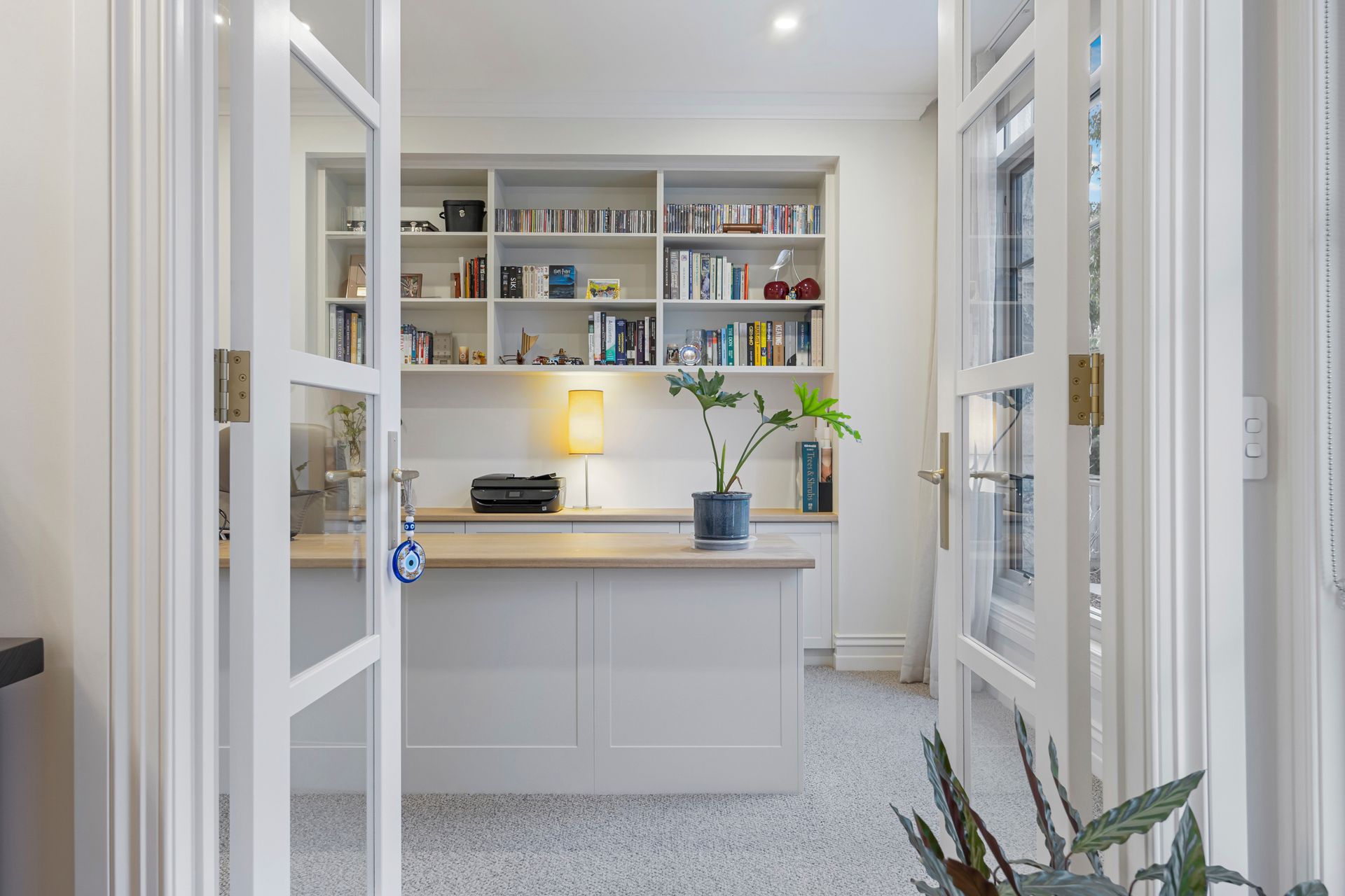 Home office with French doors, bookshelves and natural light