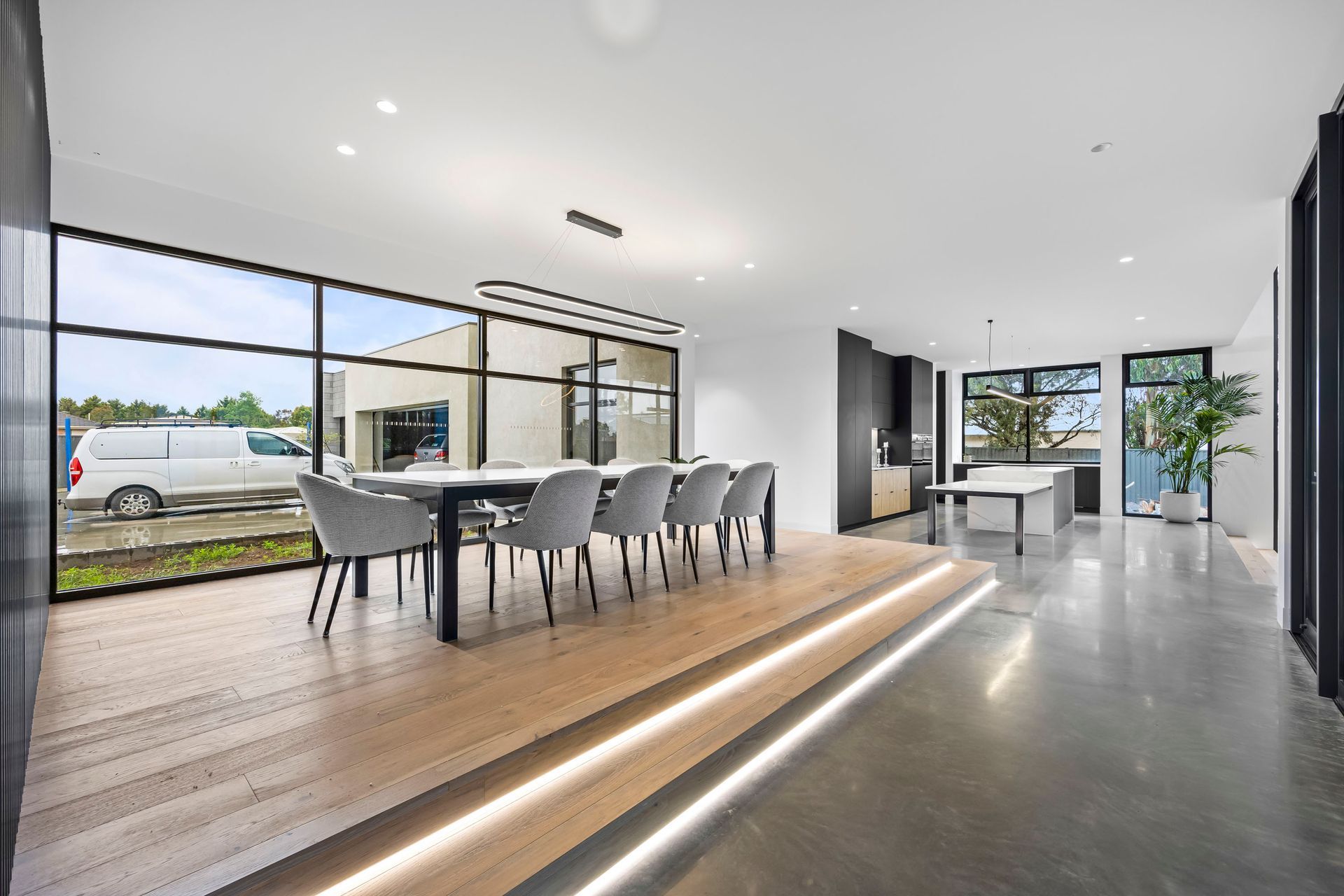 Spacious dining area with timber floors and ambient LED strip lighting.