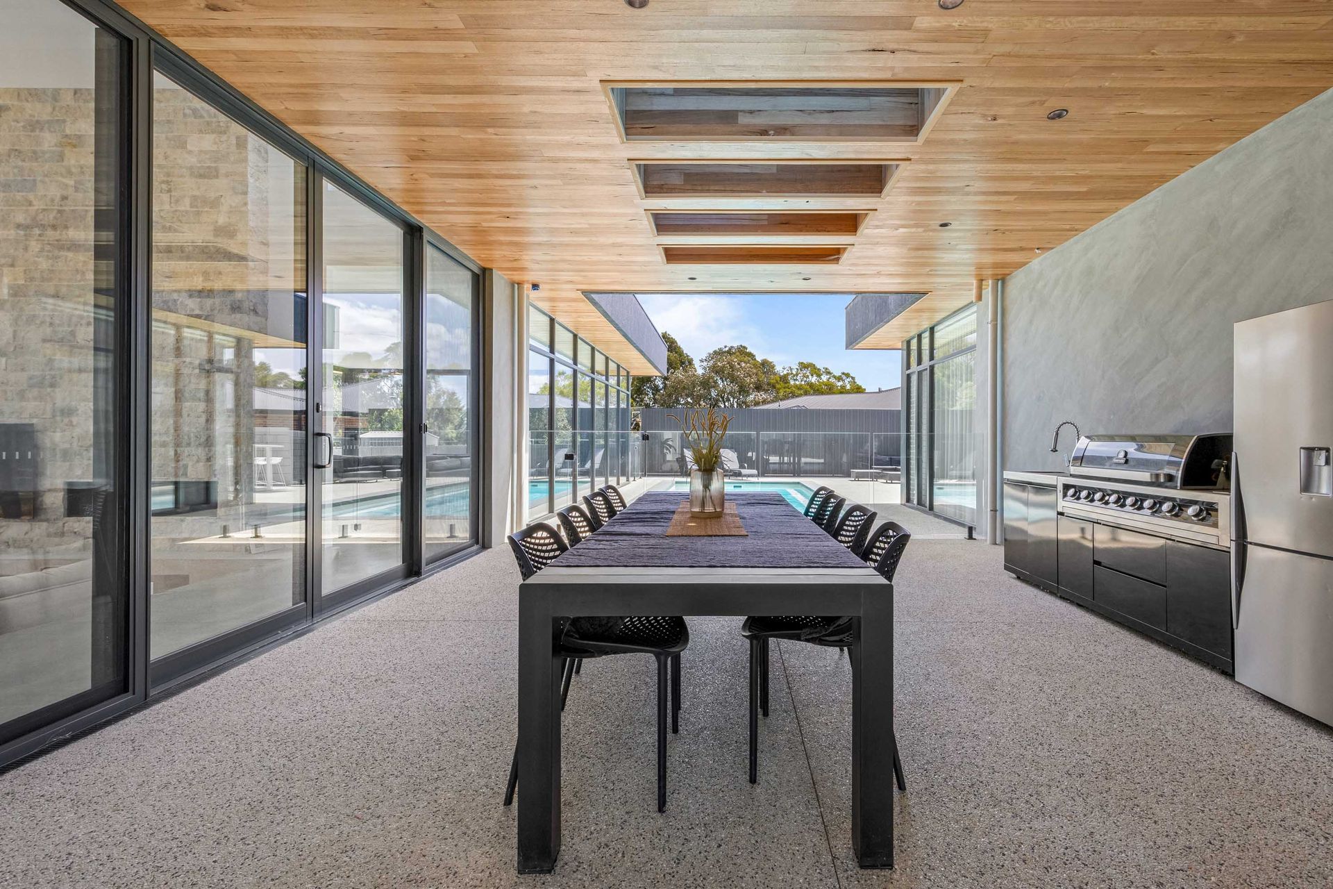Covered entertaining area overlooking the pool and backyard.