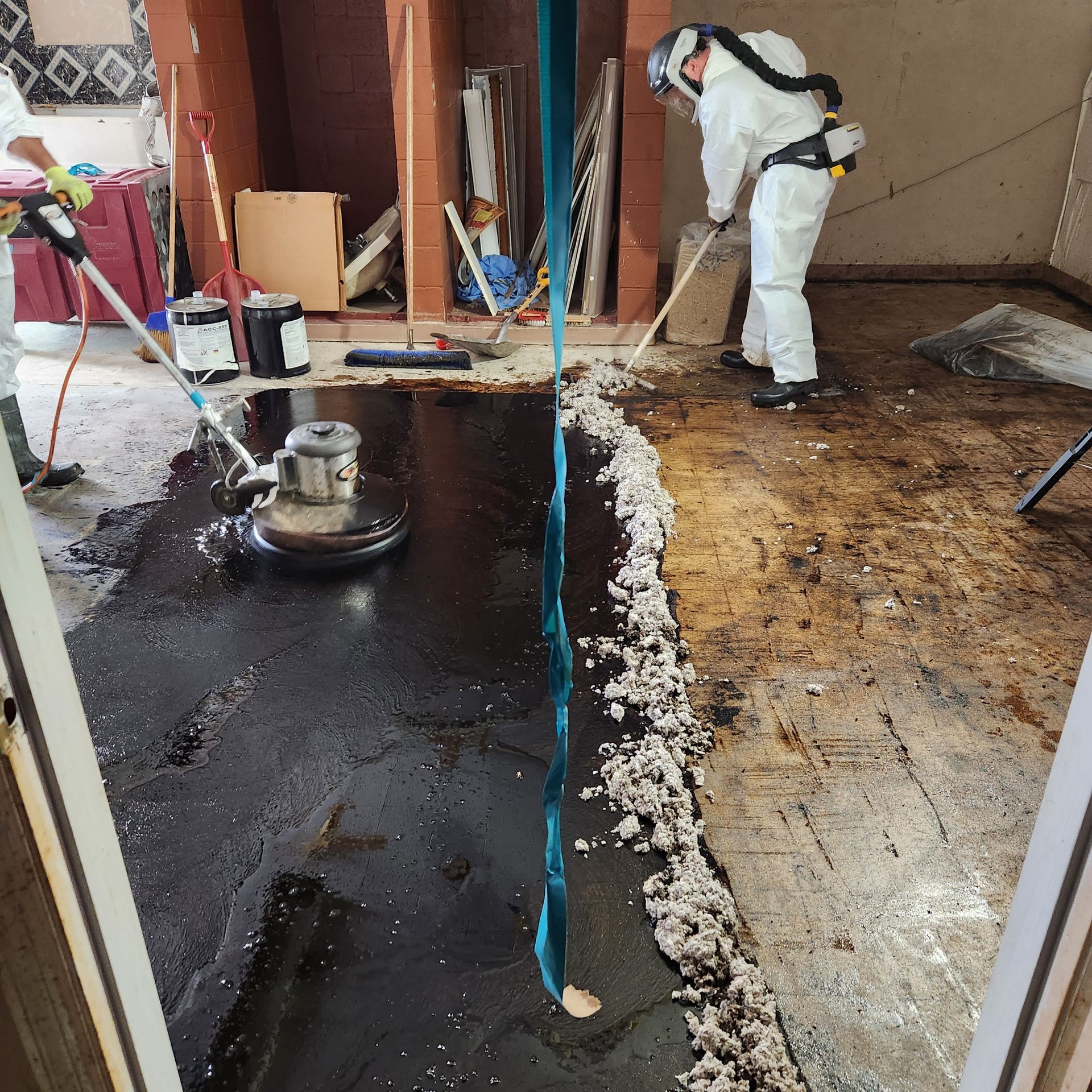 An empty room with a ceiling that has a hole in it asbestos abatement