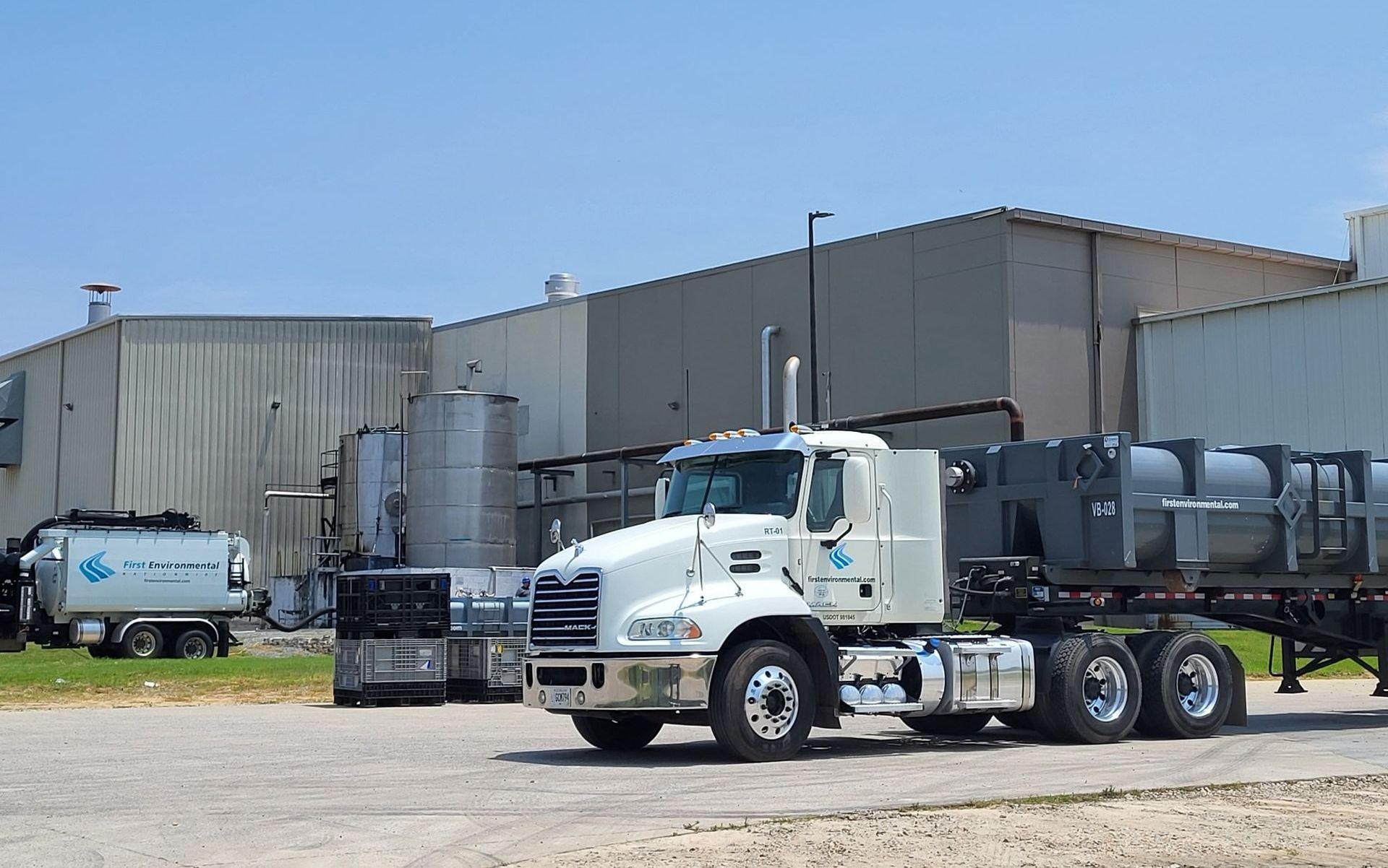 A white semi truck is parked in front of a building.