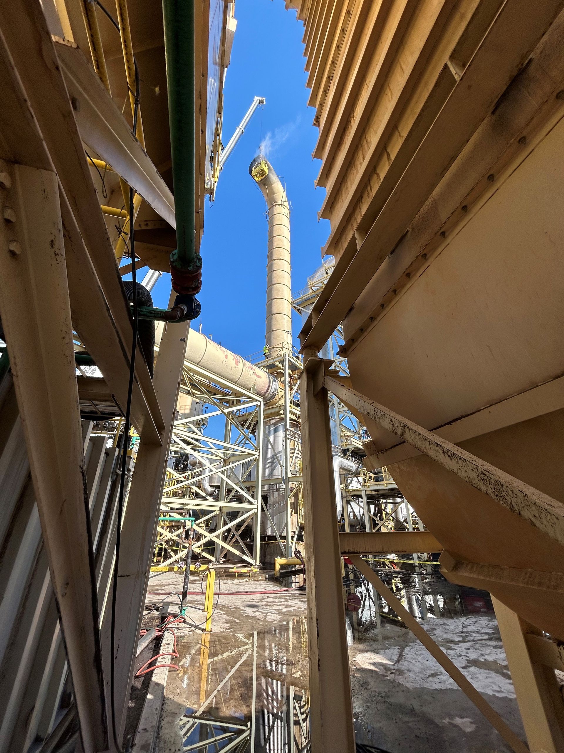Looking up at a construction site with a blue sky in the background