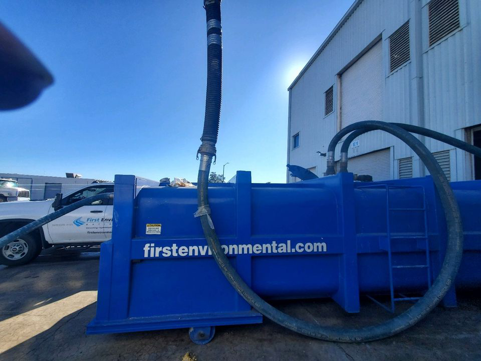 Blue tanker truck with hoses,