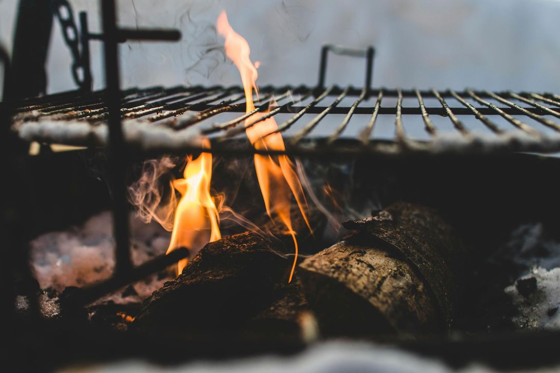 up close photo of a barbecue grill with a light amount of flames