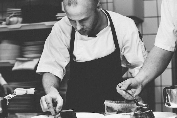Prep cook plating food for an event staffing company client in Asheville