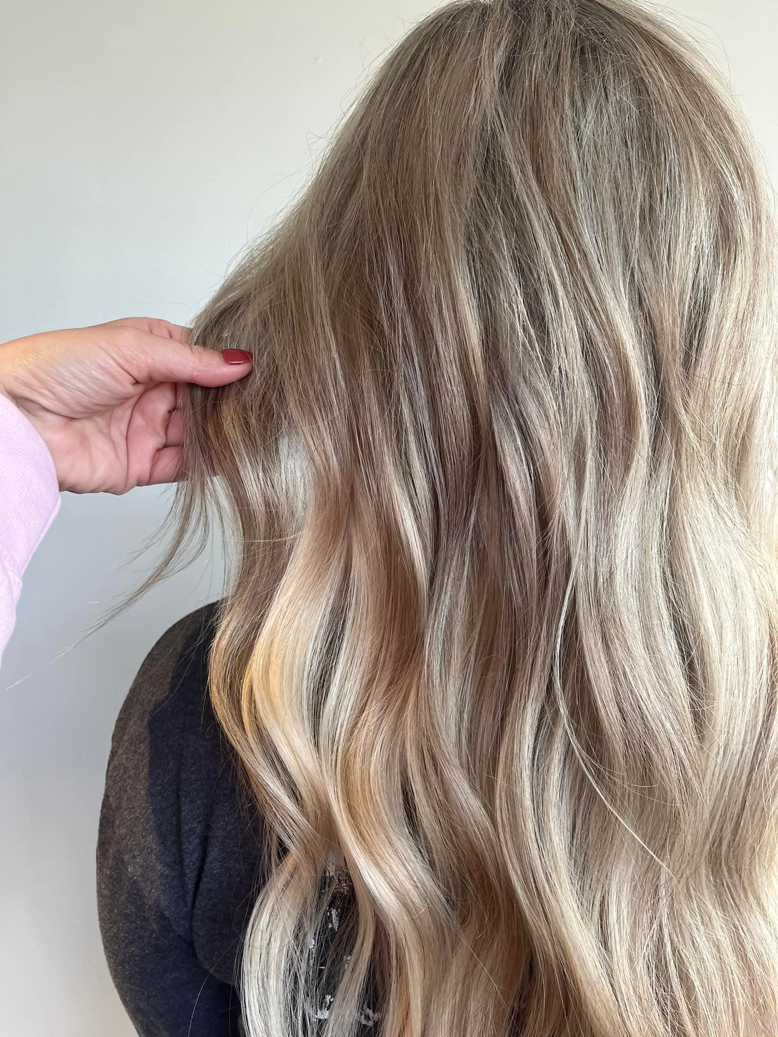 Dimensional bronde hair with blended blonde highlights and soft waves near Strafford, MO.