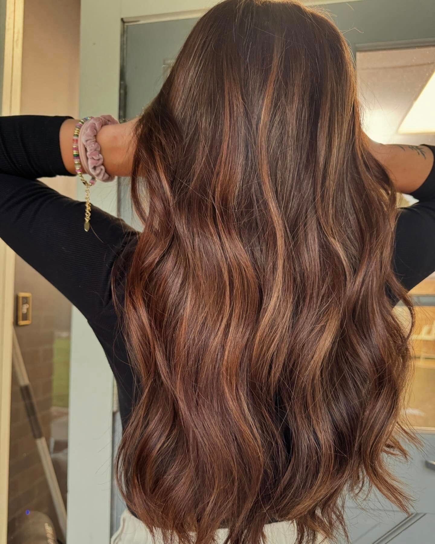 woman showing dimensional brown hair colored at top hair salon in Springfield MO