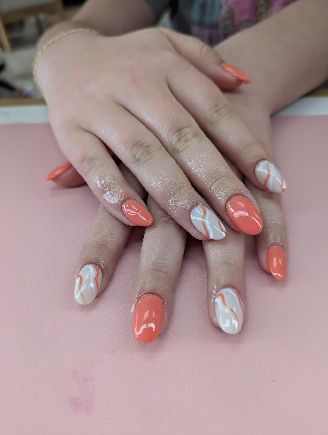 Coral and white custom manicure with modern nail art in Springfield, MO.