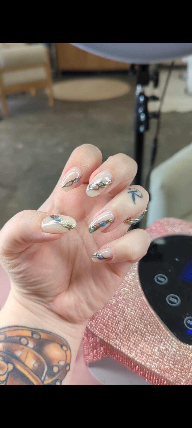 Neutral custom nail art with metallic details created by a nail artist near Nixa, MO.