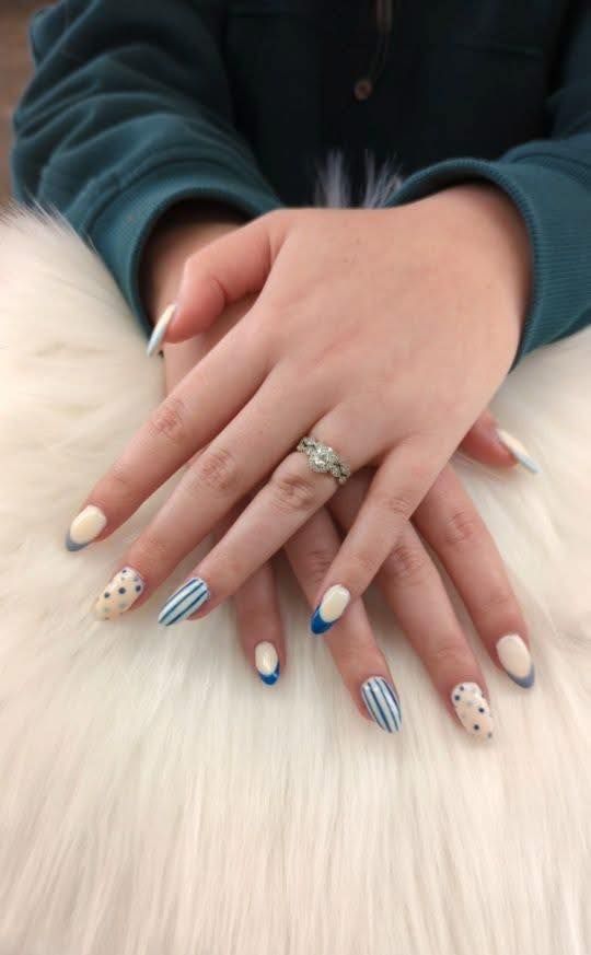 Blue and white custom nail art manicure created by a nail artist in Strafford, MO.