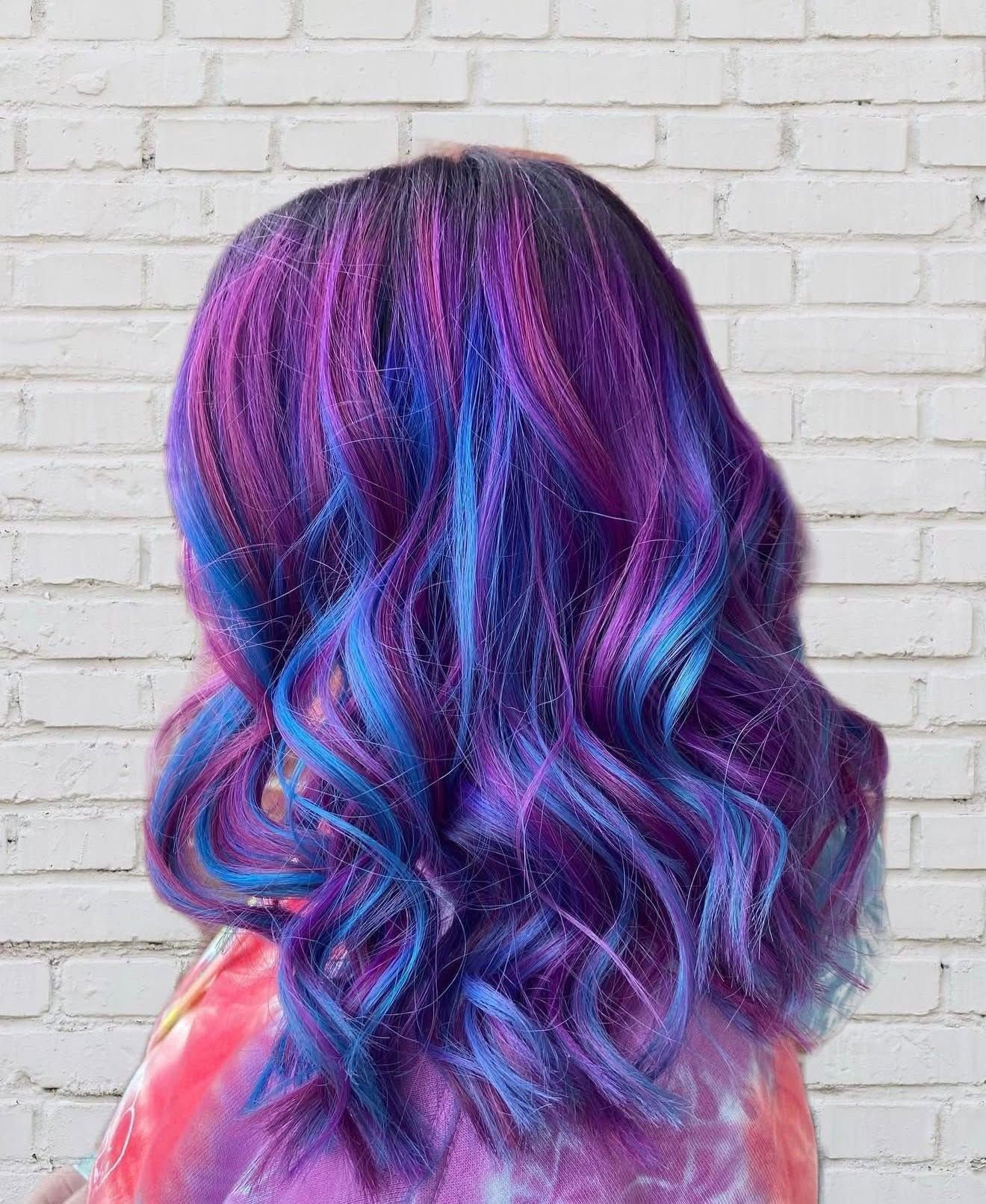 Vivid purple and blue dimensional hair color with curls near Springfield, MO.