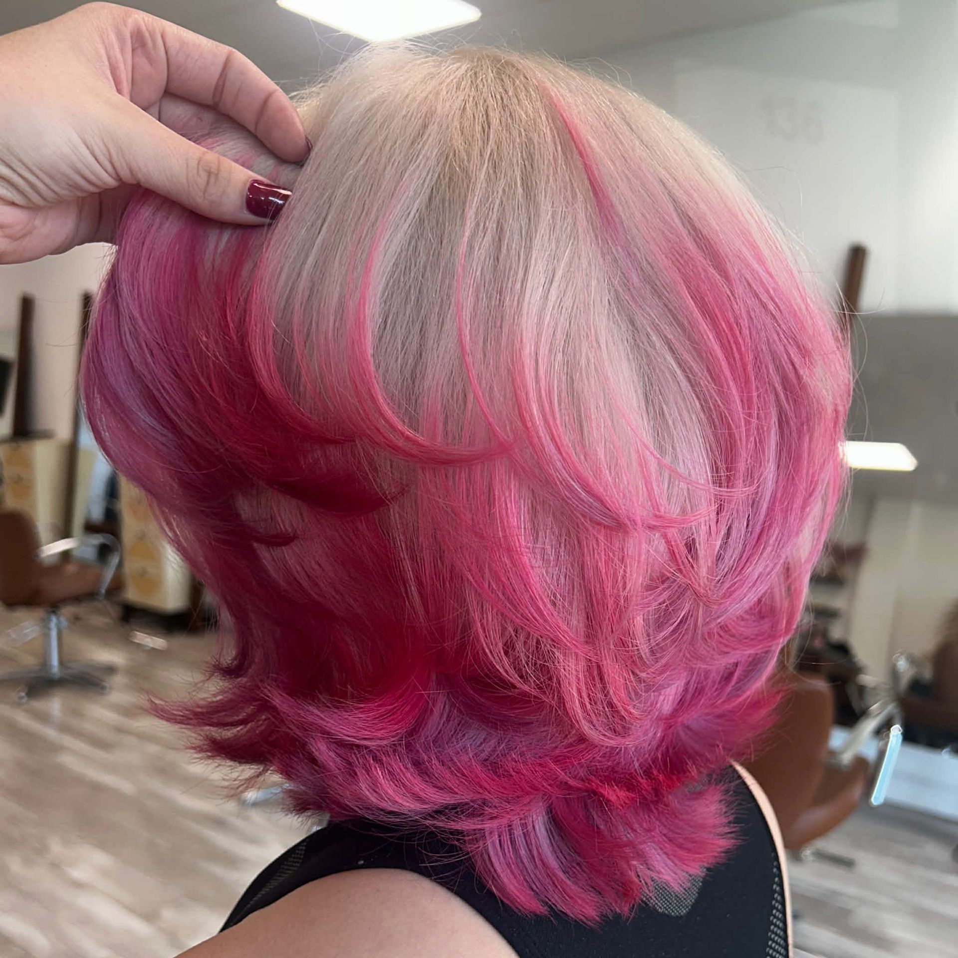Layered pink fashion hair color with bright dimensional tones near Ozark, MO.