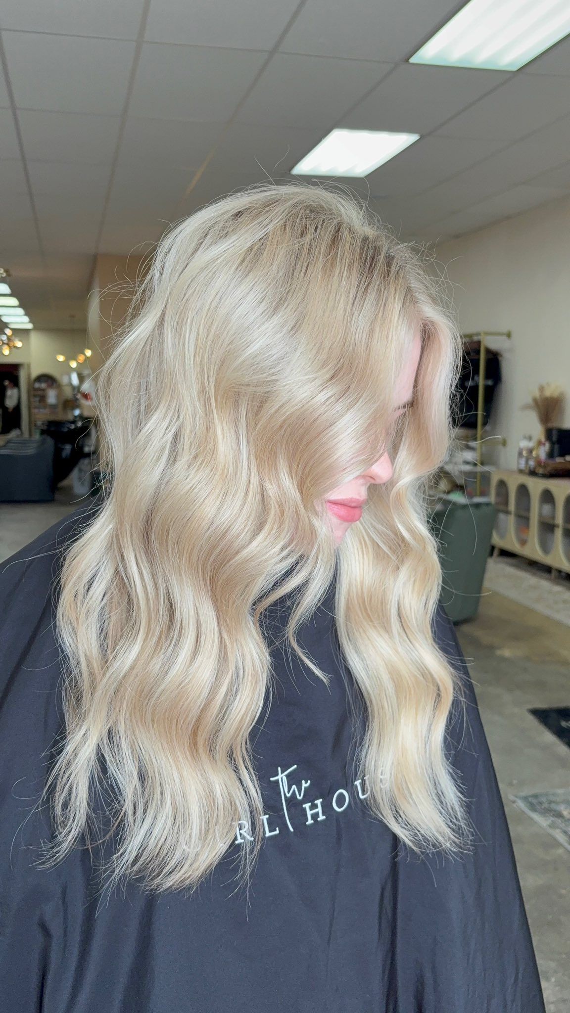 Soft dimensional blonde balayage with loose waves styled inside luxury Springfield hair salon