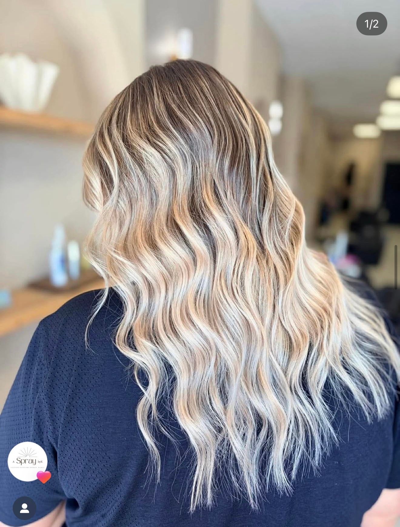 Dimensional blonde hair with soft waves and darker roots