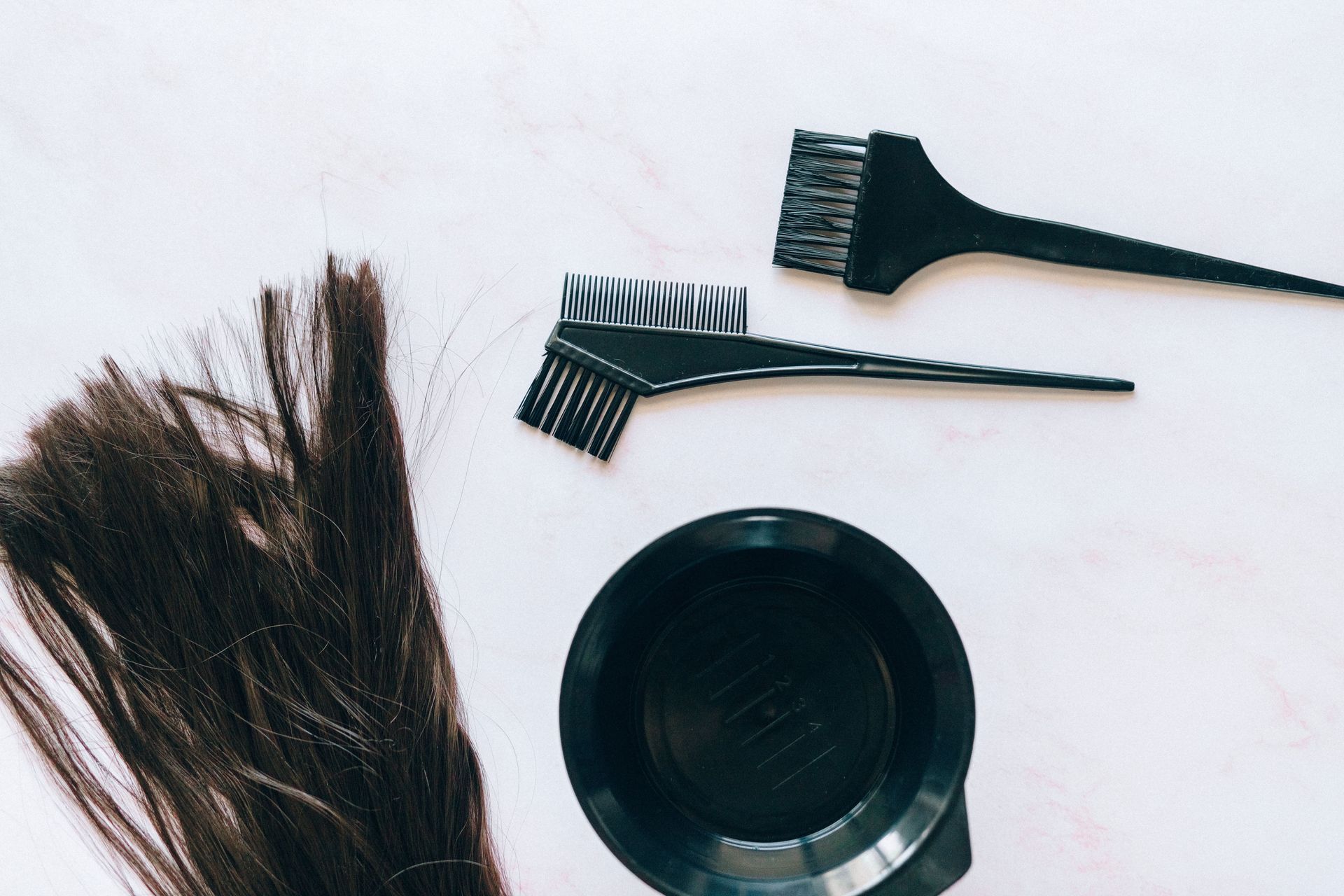 Hair dye tools and bowls on a white surface in Springfield, MO