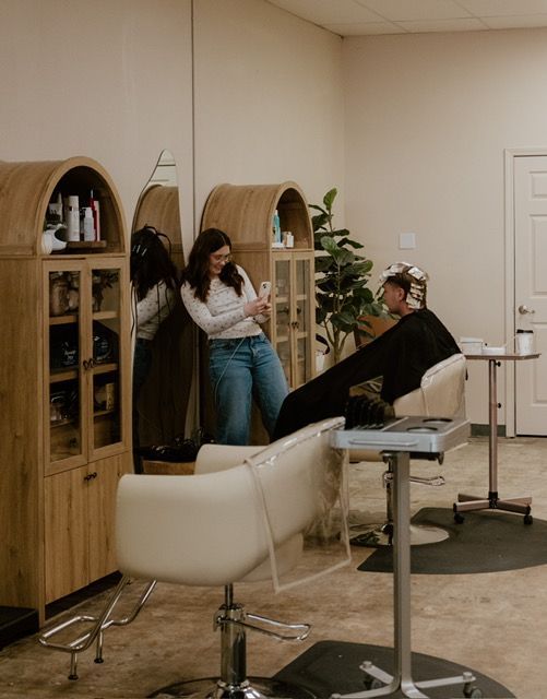 Hair stylist providing professional color services to a client at a Springfield, MO hair salon.