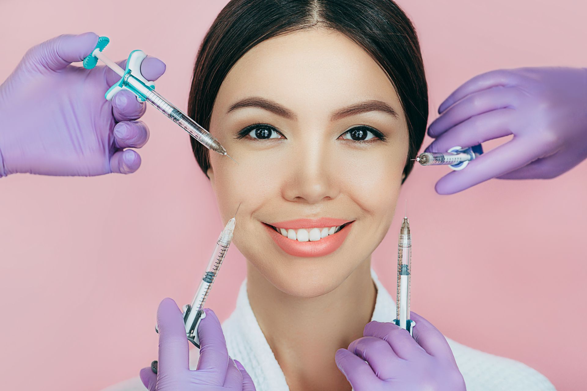 Woman receiving Botox and dermal filler injections with syringes near face in clean med spa setting