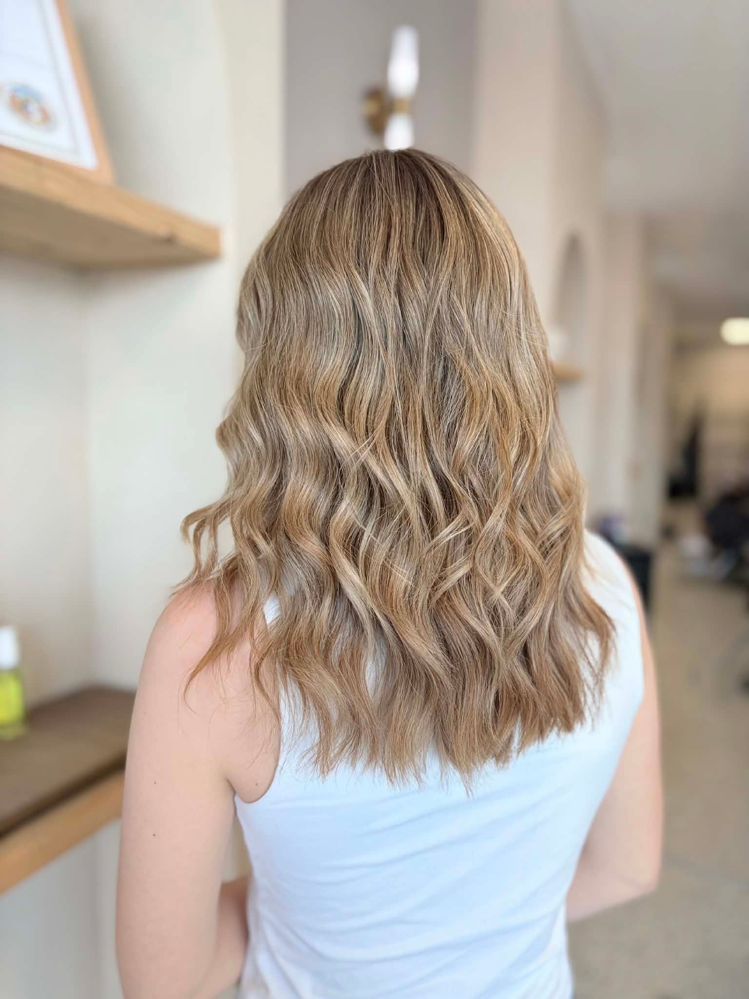 Long beige blonde hair with subtle dimension and loose waves
